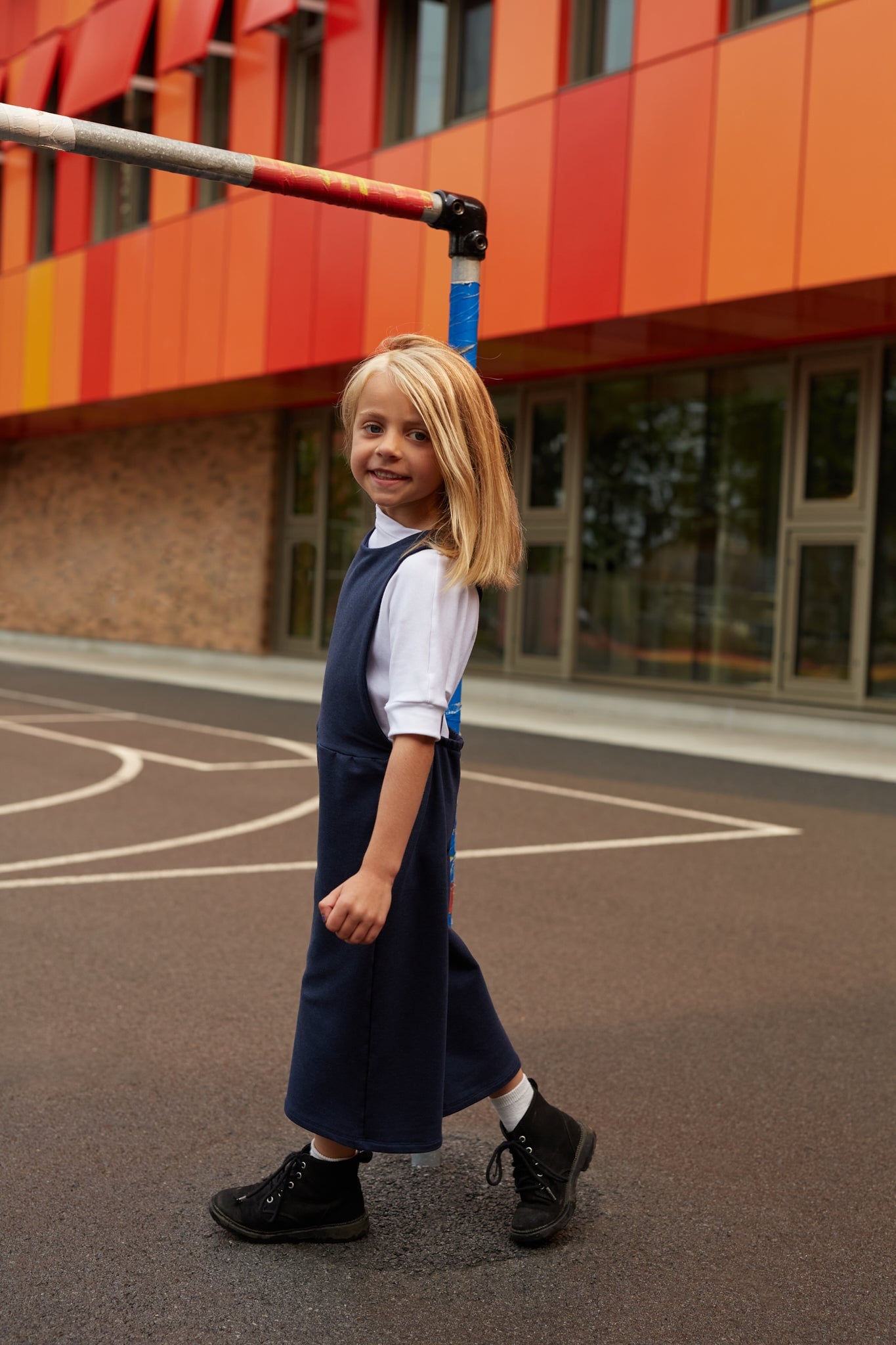 White grow-with-me t-shirt for kids, made from soft organic cotton with a stretchy, foldable waistband. Ethically made in Canada for a sustainable and comfy fit.
