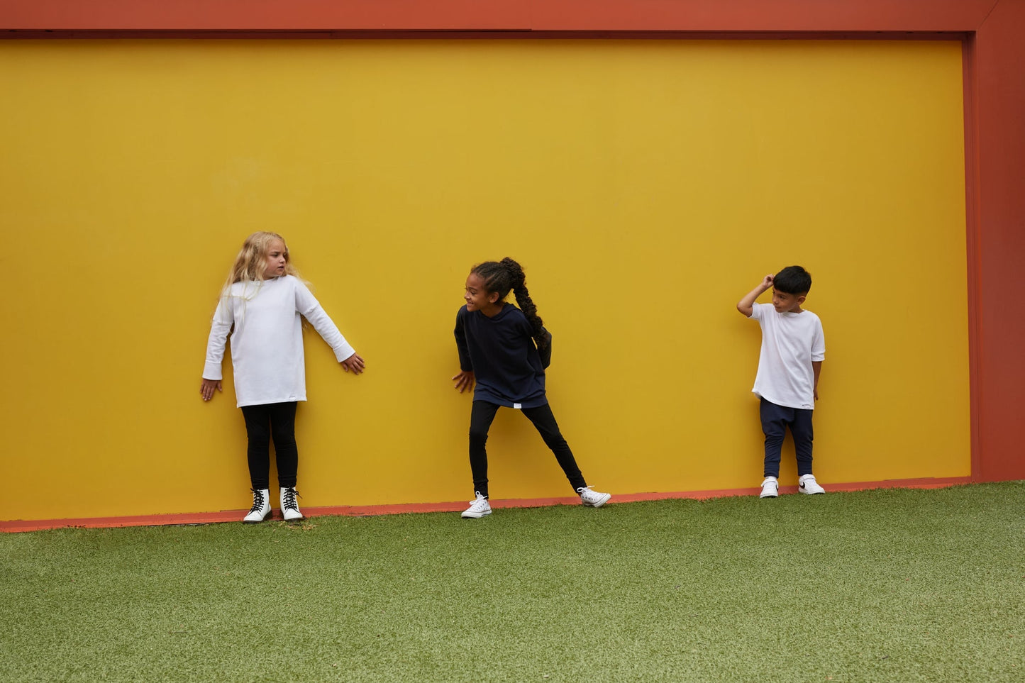 White grow-with-me shirt for toddlers and kids, designed to be worn as a dress, tunic, or long shirt. Seamless shoulders and soft, eco-friendly fabric. Ethically made in Canada.