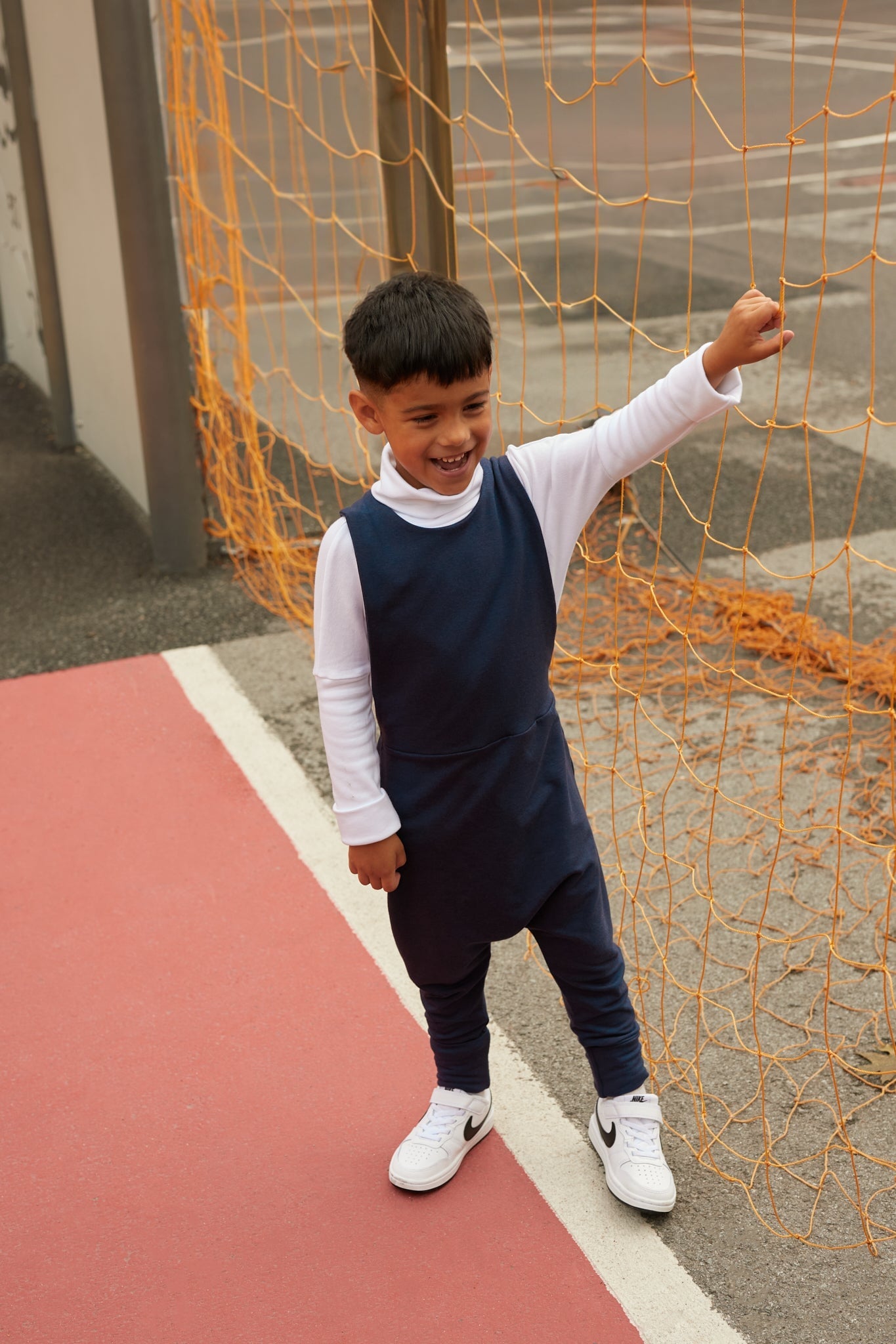 navy grow-with-me overalls for toddlers and kids, made from soft, eco-friendly fabric. Adjustable straps and cuffs for a long-lasting fit. Ethically made in Canada.