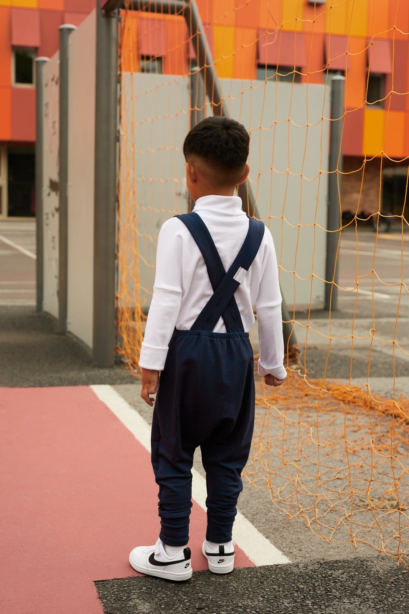 navy grow-with-me overalls for toddlers and kids, made from soft, eco-friendly fabric. Adjustable straps and cuffs for a long-lasting fit. Ethically made in Canada.