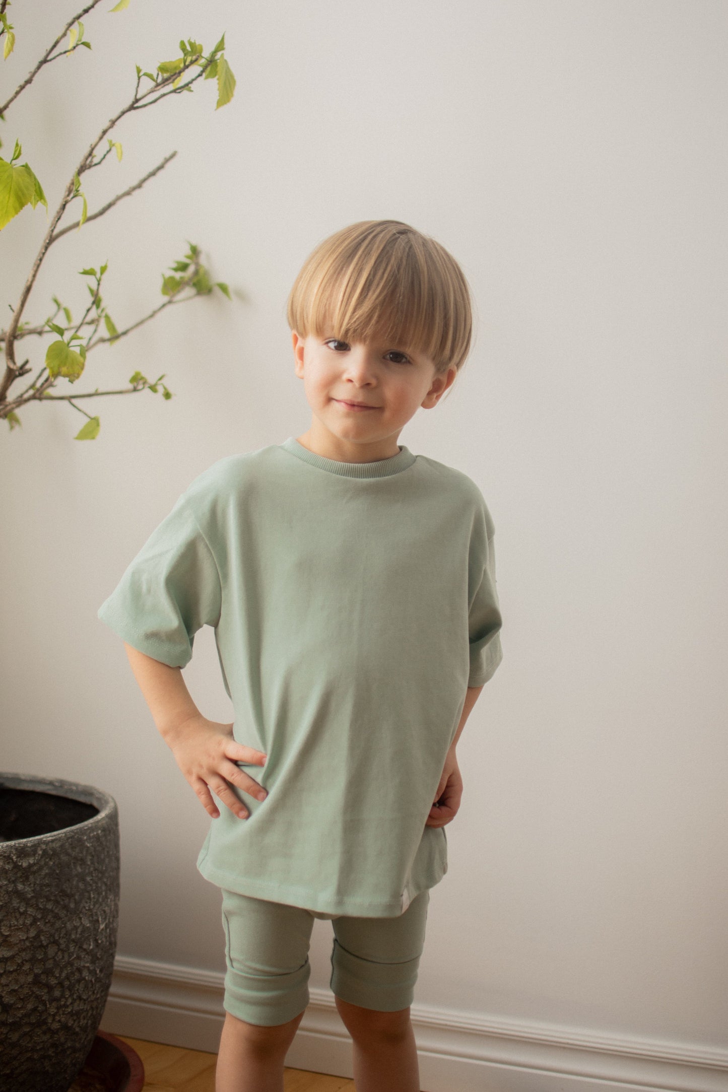 Discover our oversized Grow-With-Me T-Shirt – a gender-neutral, eco-friendly essential for kids. Handmade in Montreal, designed for comfort and longevity.