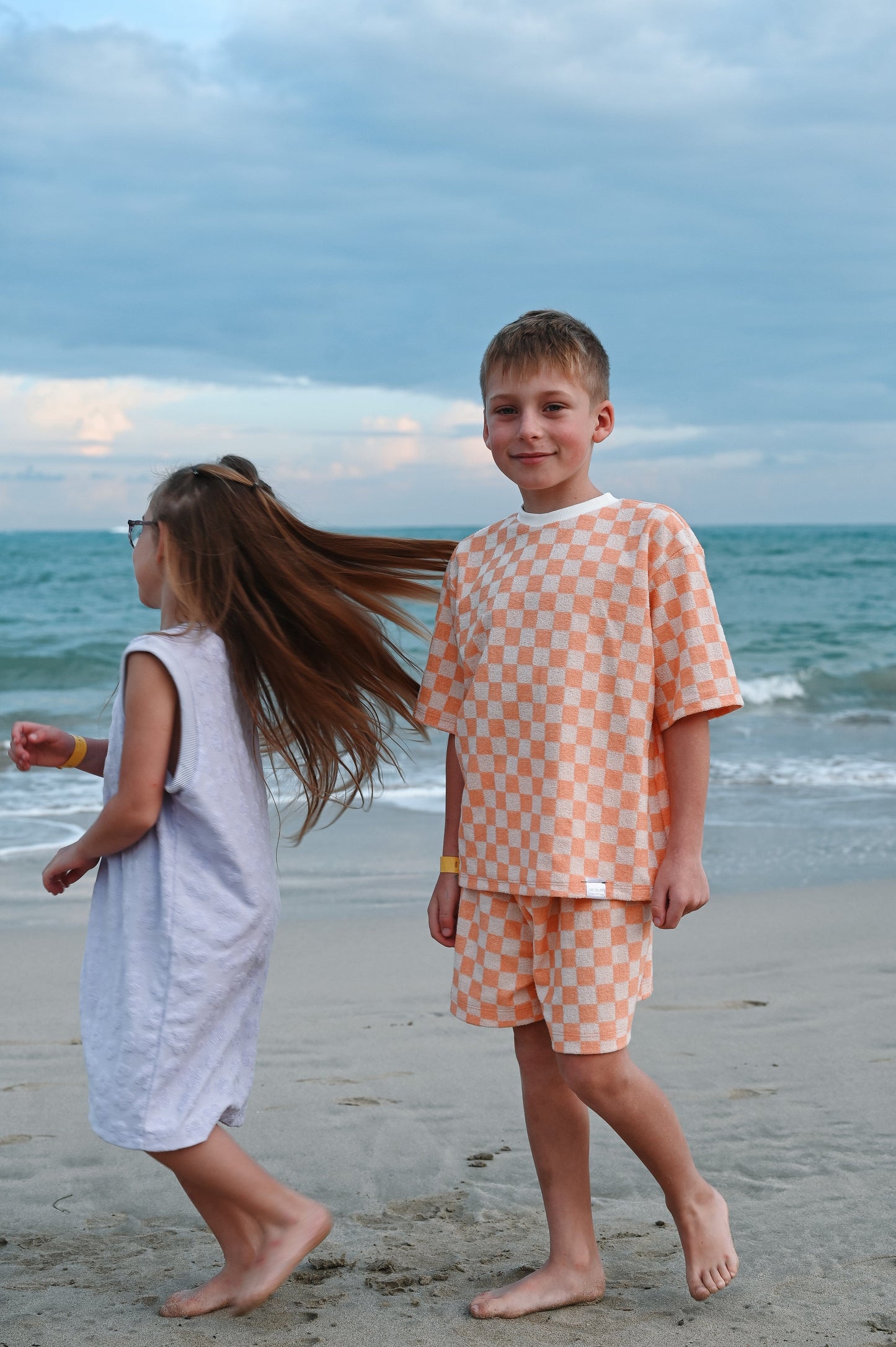 Checkered orange oversize kids t-shirt made in Canada with eco-friendly fabric designed to grow with your child