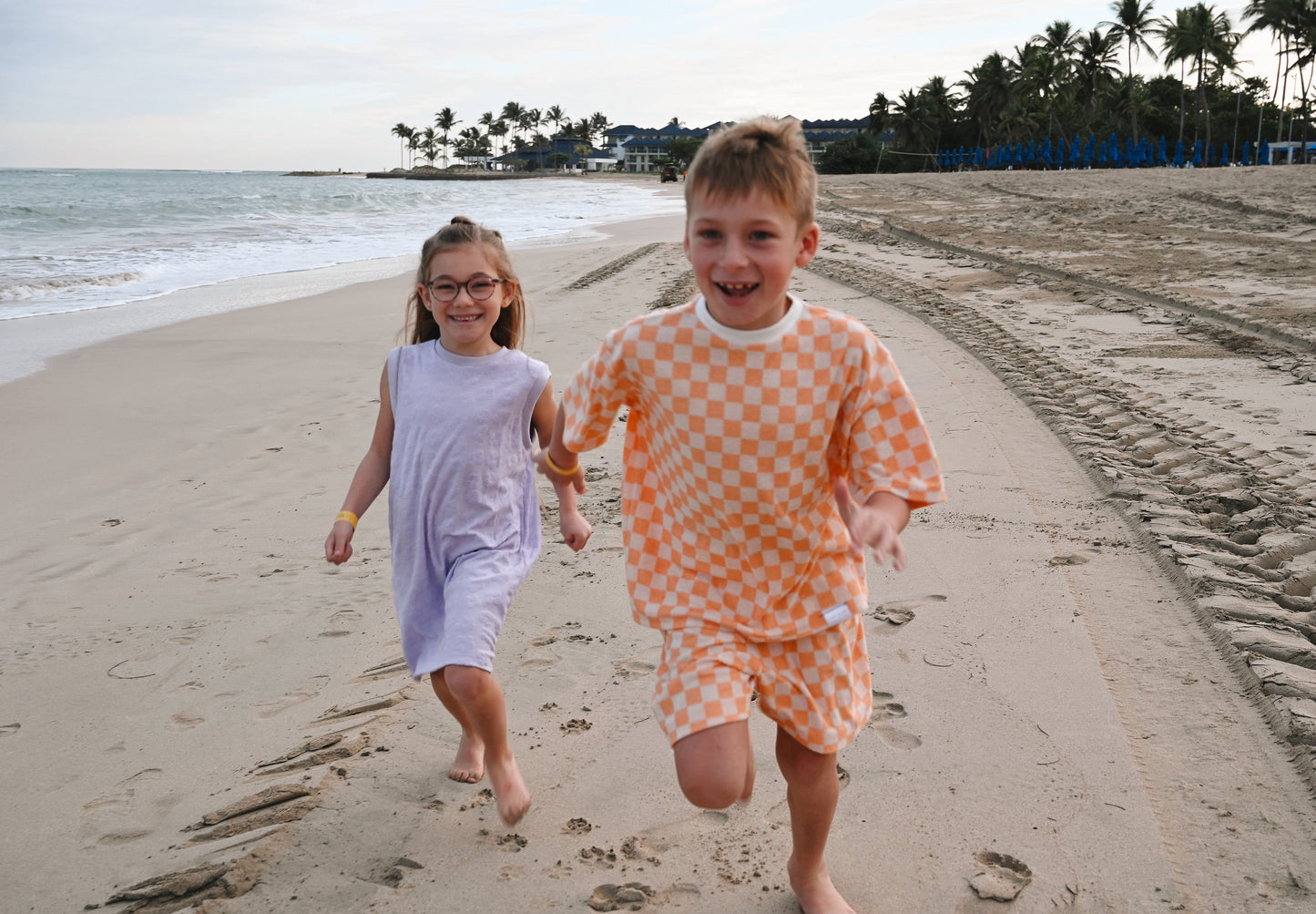 Checkered orange loose kids short made in Canada with eco-friendly fabric designed to grow with your child