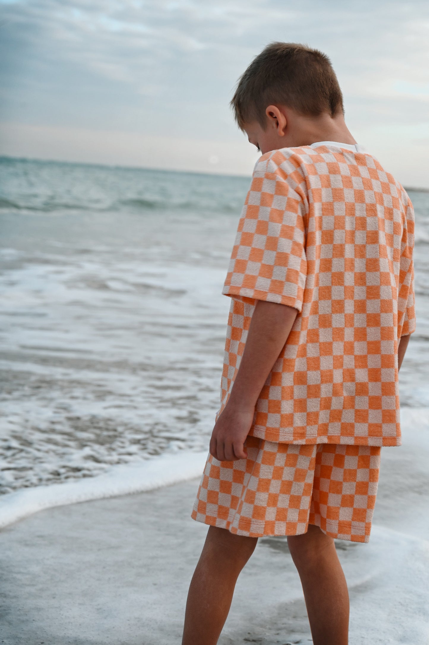 Checkered orange oversize kids t-shirt made in Canada with eco-friendly fabric designed to grow with your child
