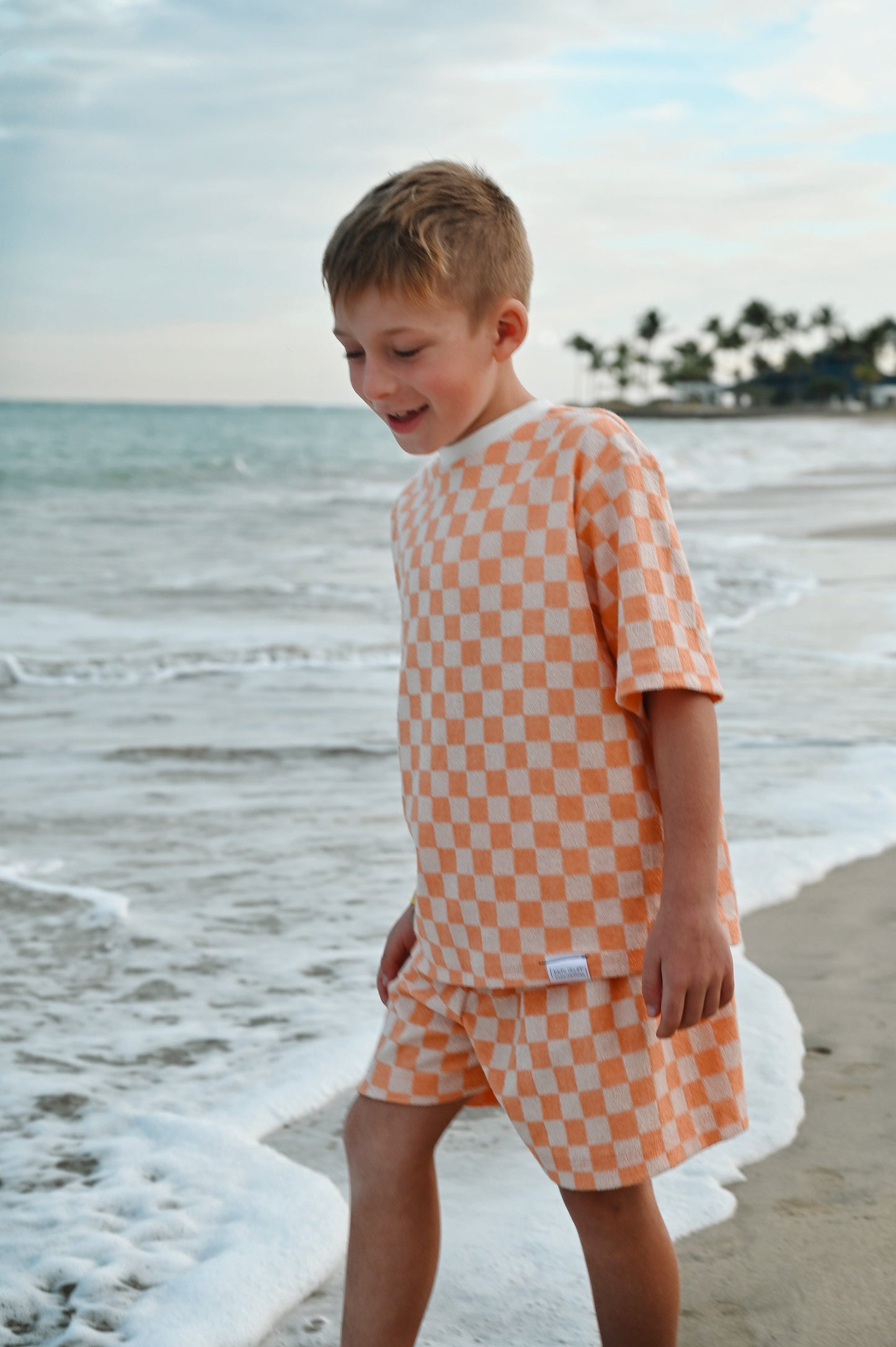 Checkered orange loose kids short made in Canada with eco-friendly fabric designed to grow with your child