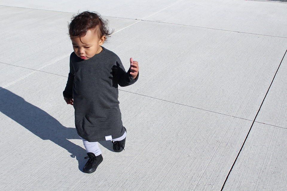 Dark Grey grow-with-me shirt for toddlers and kids, designed to be worn as a dress, tunic, or long shirt. Seamless shoulders and soft, eco-friendly fabric. Ethically made in Canada.