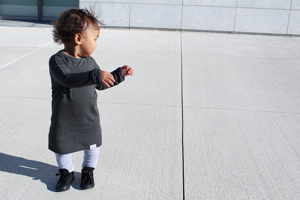 Dark Grey grow-with-me shirt for toddlers and kids, designed to be worn as a dress, tunic, or long shirt. Seamless shoulders and soft, eco-friendly fabric. Ethically made in Canada.
