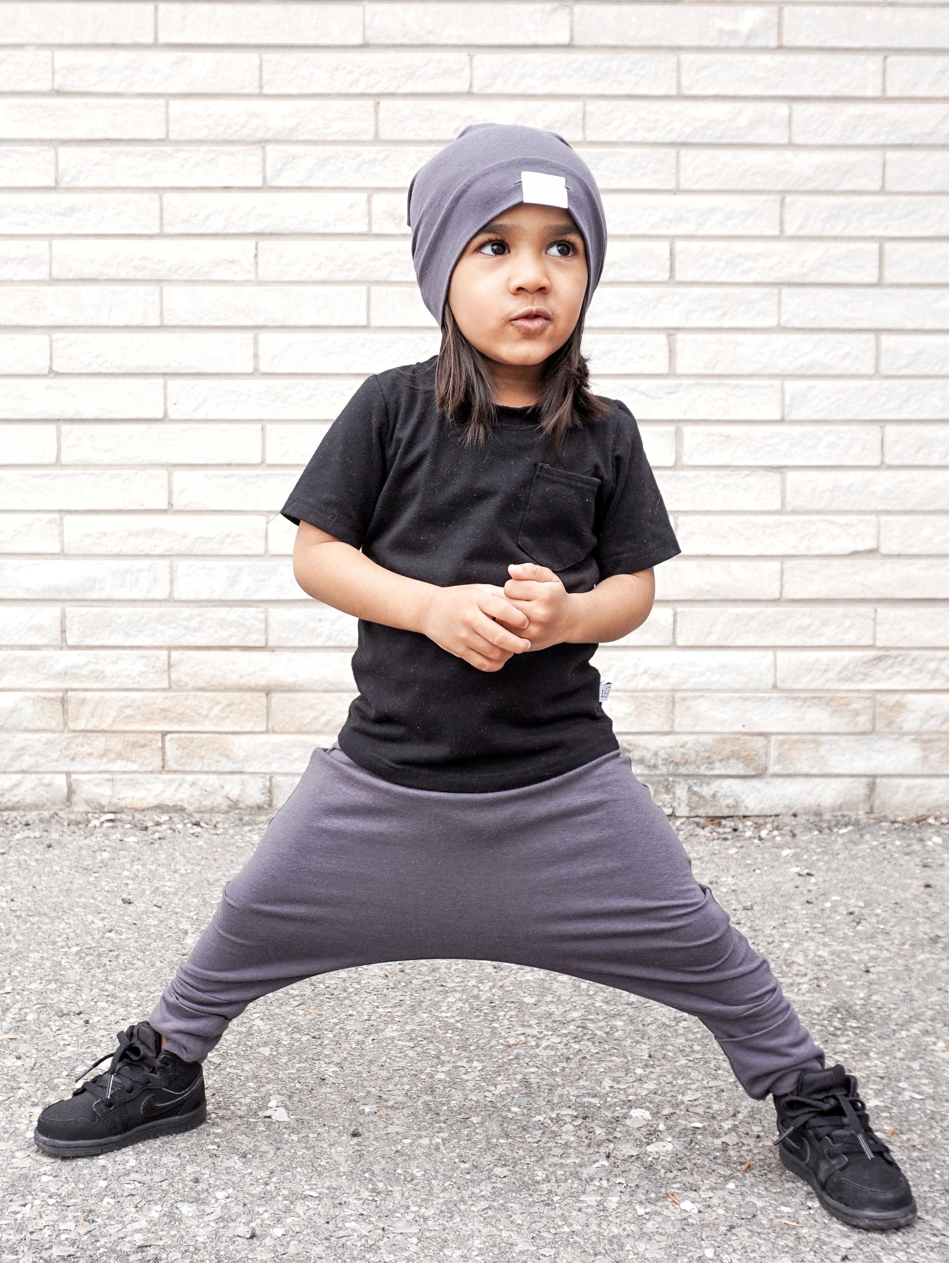 Dark Grey grow-with-me pants for toddlers and kids, made from soft, eco-friendly fabric. Adjustable waistband and cuffs for extended wear. Ethically made in Canada.
