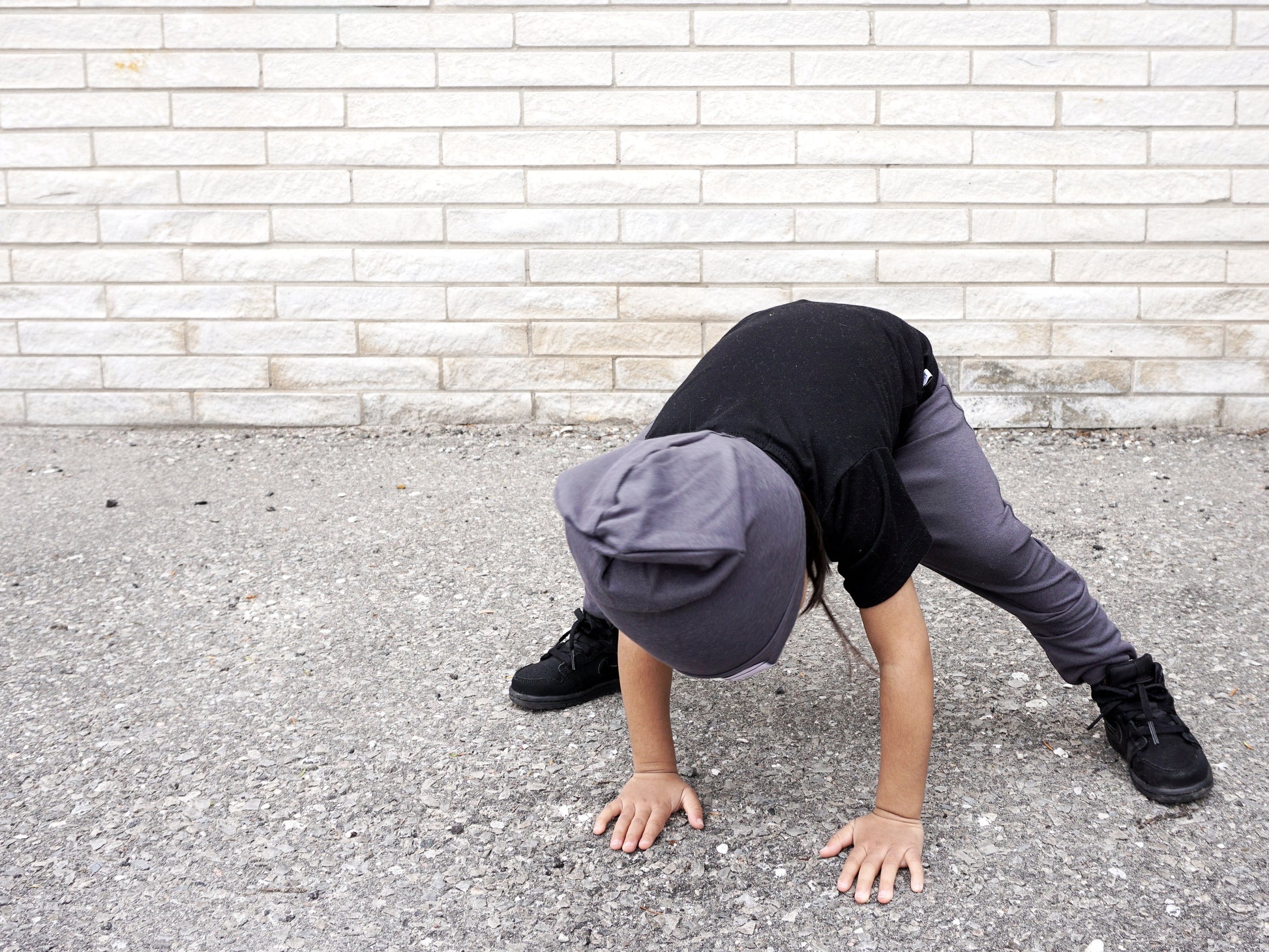 Soft and stretchy dark grey beanie for kids, made from eco-friendly fabric. Ethically crafted in Canada, featuring a fold-over brim and minimalist design