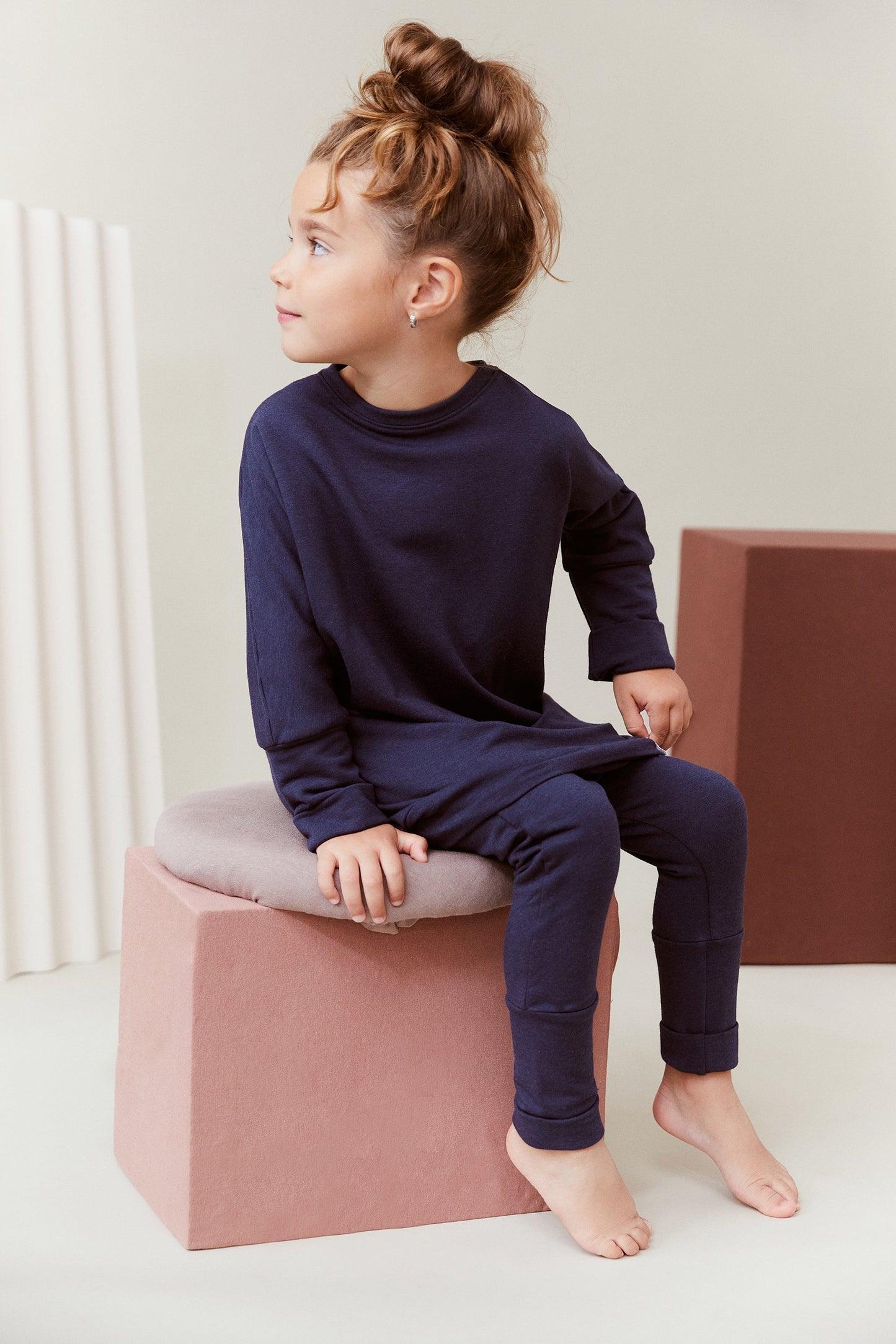 Navy grow-with-me pants for toddlers and kids, made from soft, eco-friendly fabric. Adjustable waistband and cuffs for extended wear. Ethically made in Canada.