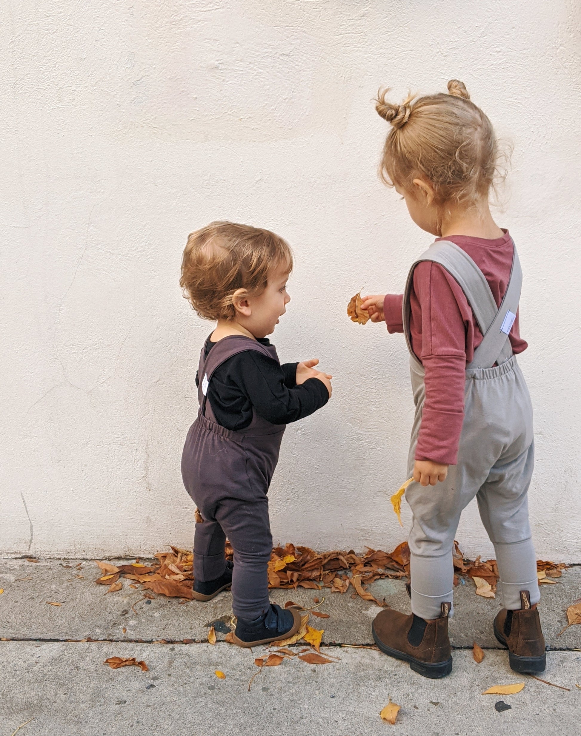 Dark grey grow-with-me overalls for toddlers and kids, made from soft, eco-friendly fabric. Adjustable straps and cuffs for a long-lasting fit. Ethically made in Canada.