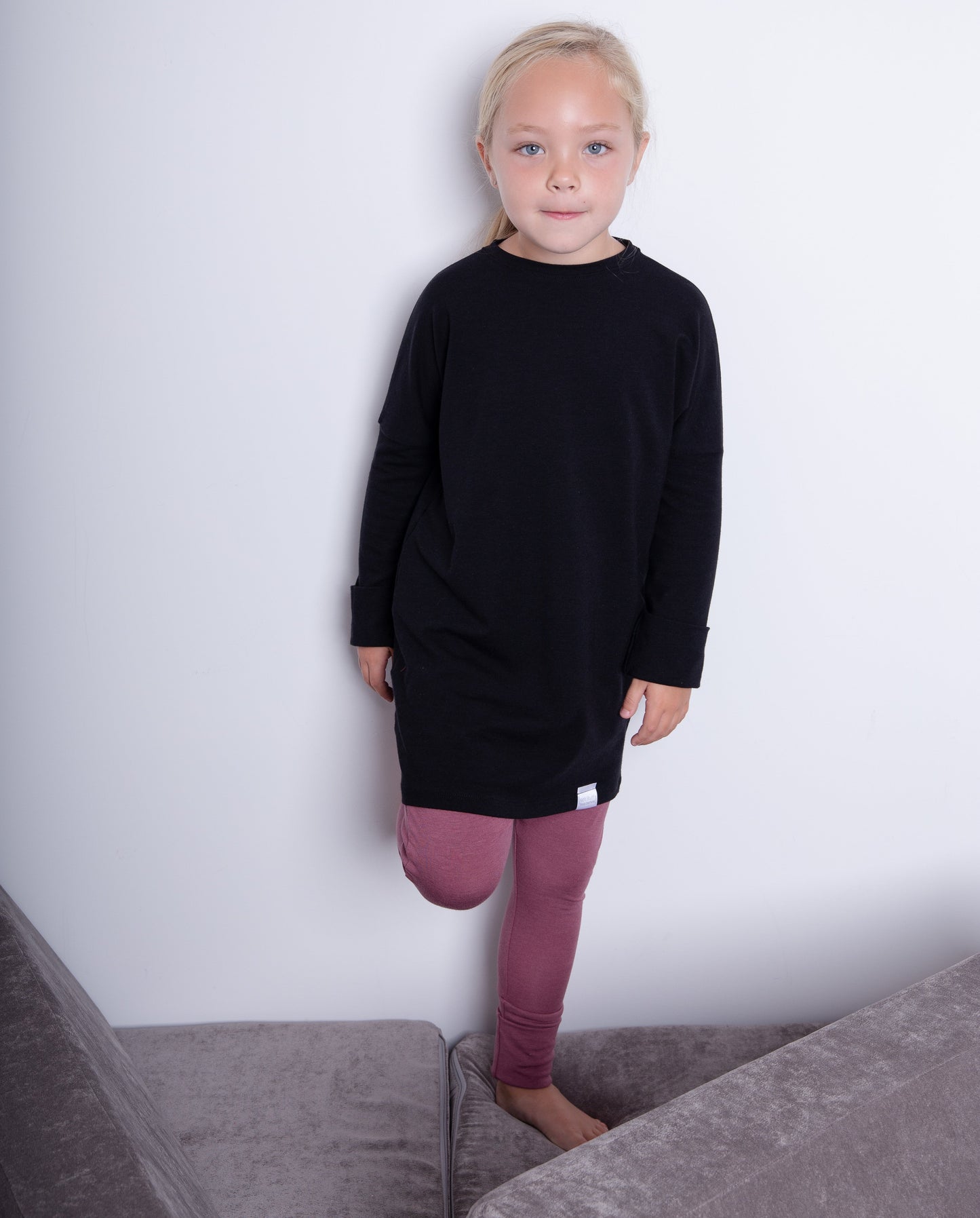 Black grow-with-me shirt for toddlers and kids, designed to be worn as a dress, tunic, or long shirt. Seamless shoulders and soft, eco-friendly fabric. Ethically made in Canada.