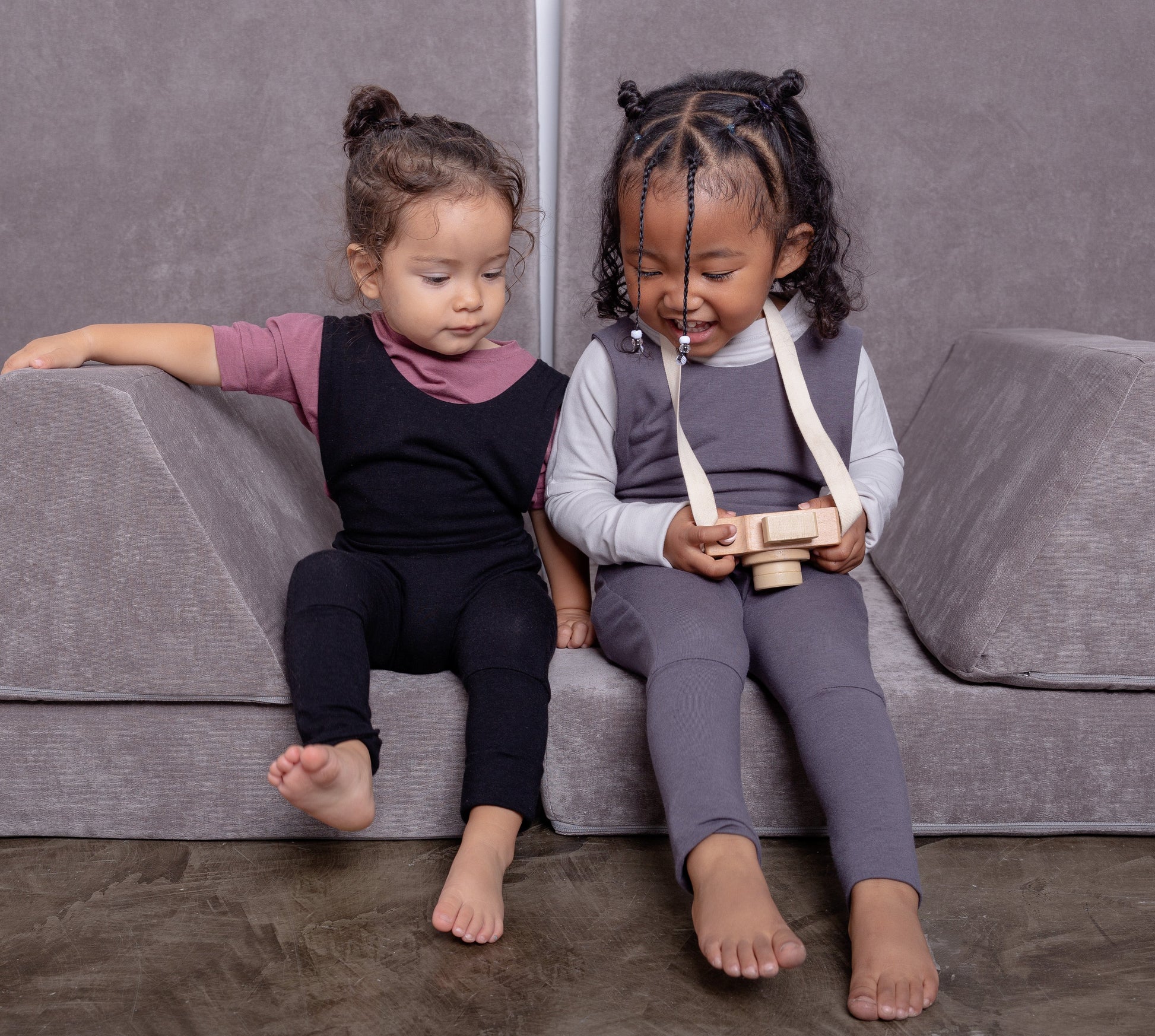 black grow-with-me overalls for toddlers and kids, made from soft, eco-friendly fabric. Adjustable straps and cuffs for a long-lasting fit. Ethically made in Canada.