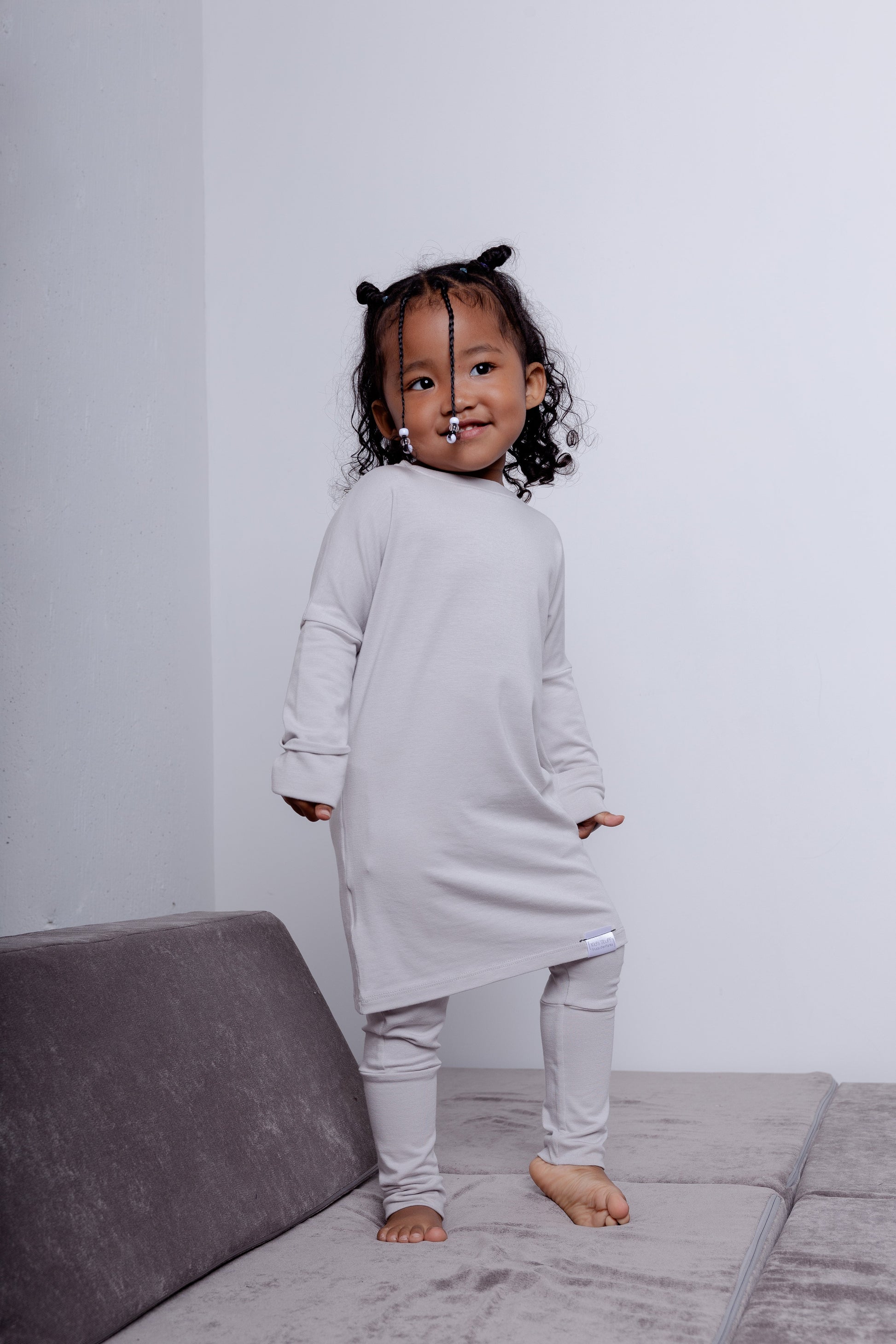 Taupe grow-with-me shirt for toddlers and kids, designed to be worn as a dress, tunic, or long shirt. Seamless shoulders and soft, eco-friendly fabric. Ethically made in Canada.