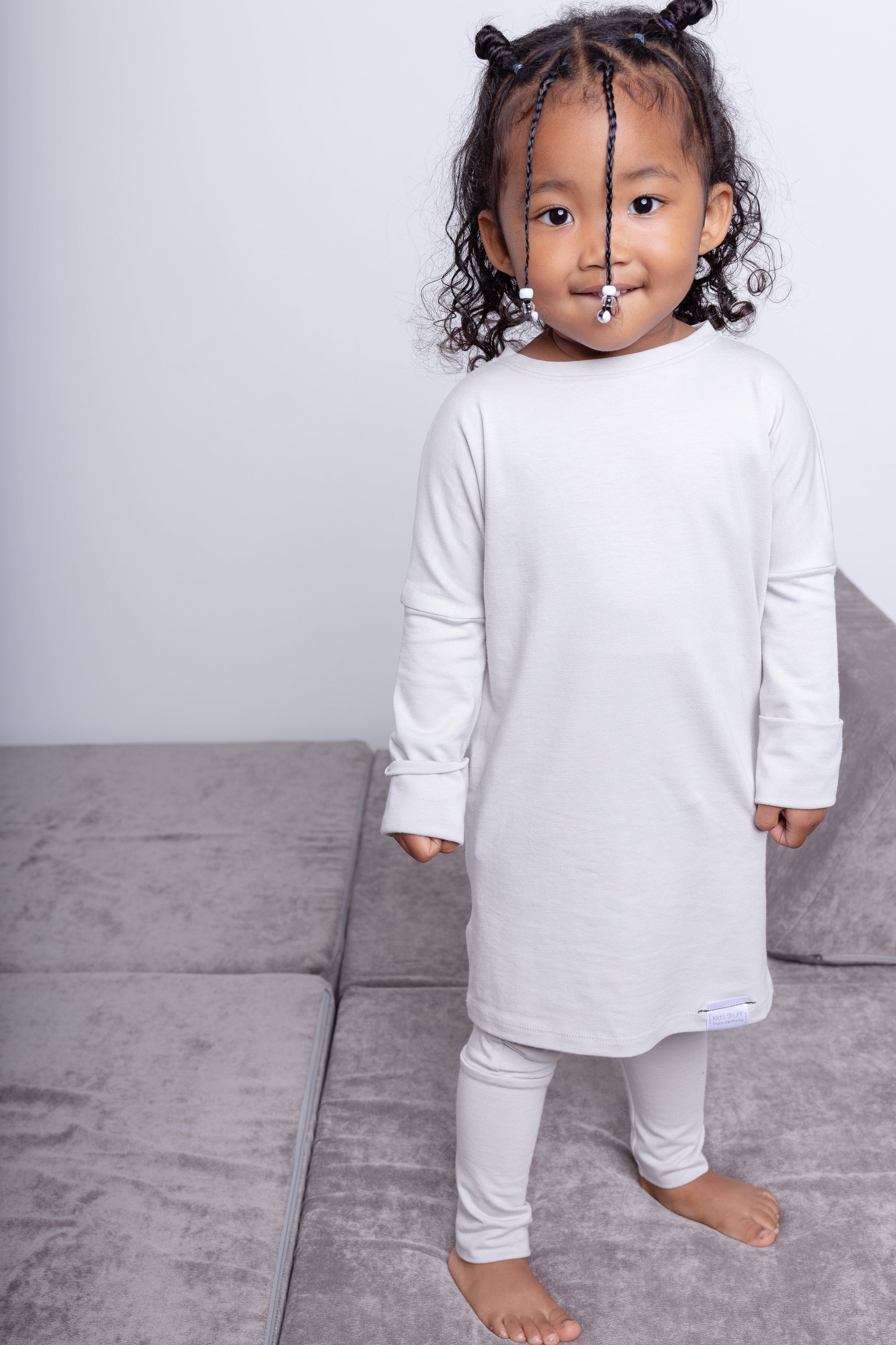 Taupe grow-with-me shirt for toddlers and kids, designed to be worn as a dress, tunic, or long shirt. Seamless shoulders and soft, eco-friendly fabric. Ethically made in Canada.