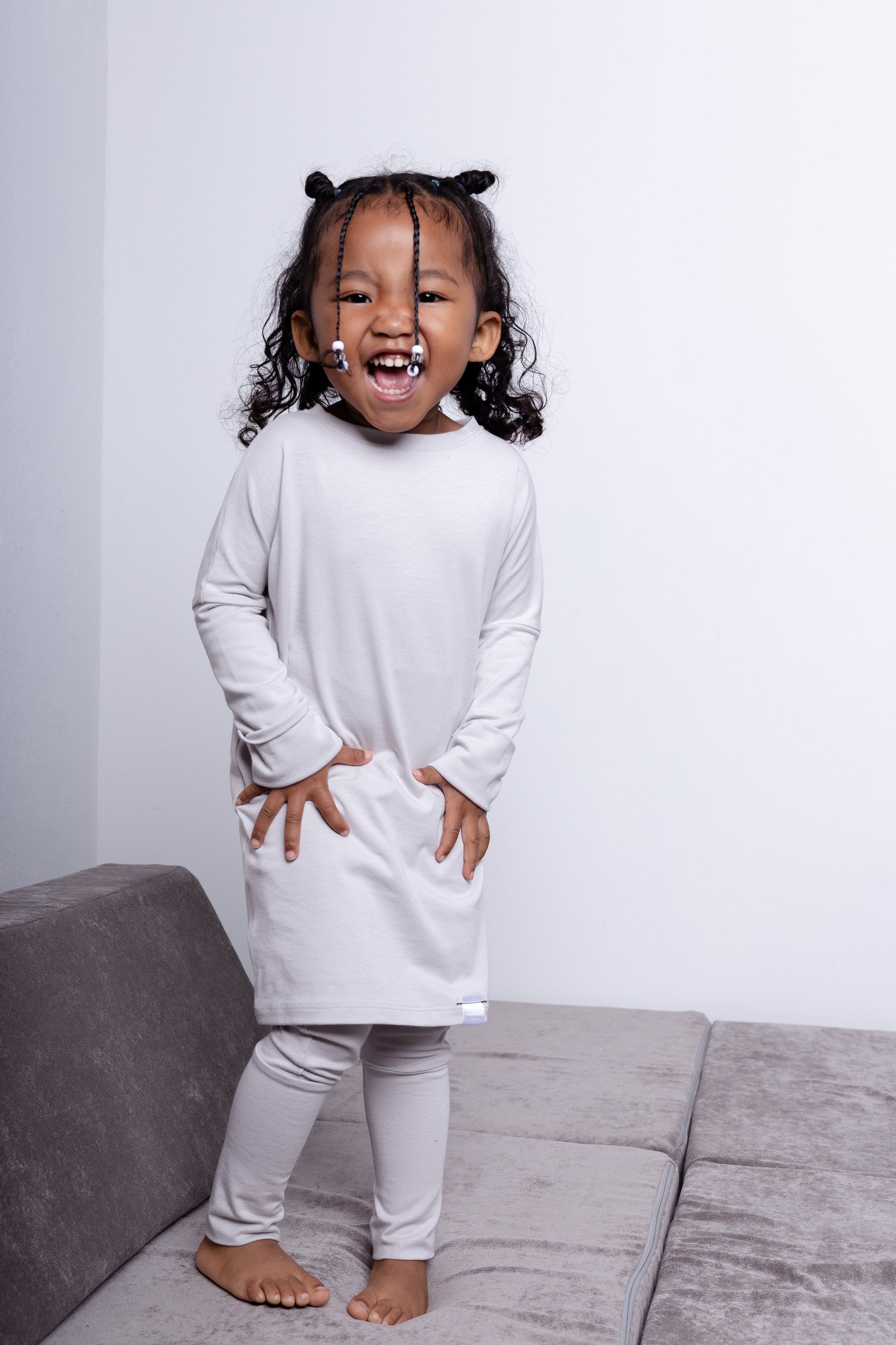 Taupe grow-with-me shirt for toddlers and kids, designed to be worn as a dress, tunic, or long shirt. Seamless shoulders and soft, eco-friendly fabric. Ethically made in Canada.