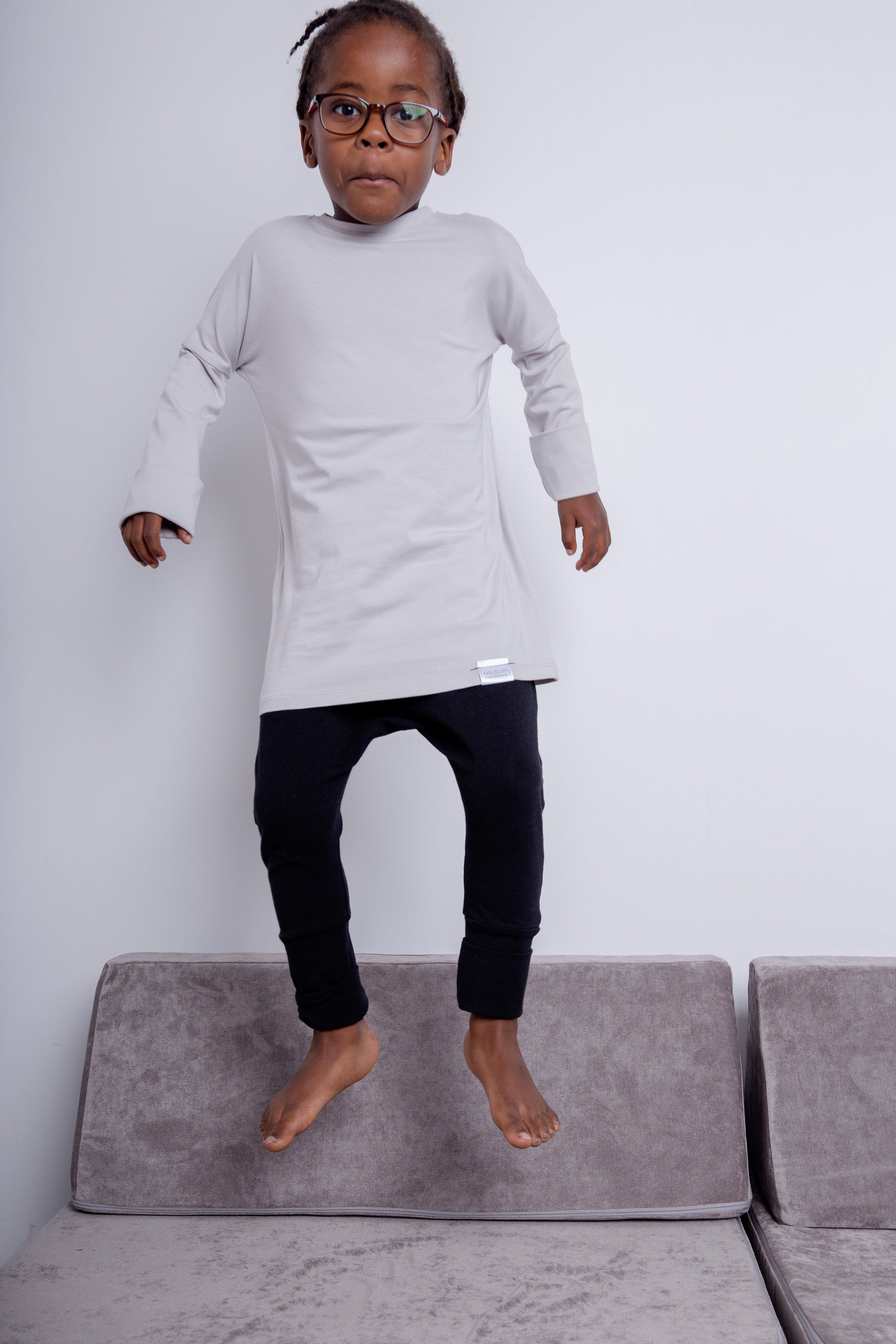 Taupe grow-with-me shirt for toddlers and kids, designed to be worn as a dress, tunic, or long shirt. Seamless shoulders and soft, eco-friendly fabric. Ethically made in Canada.