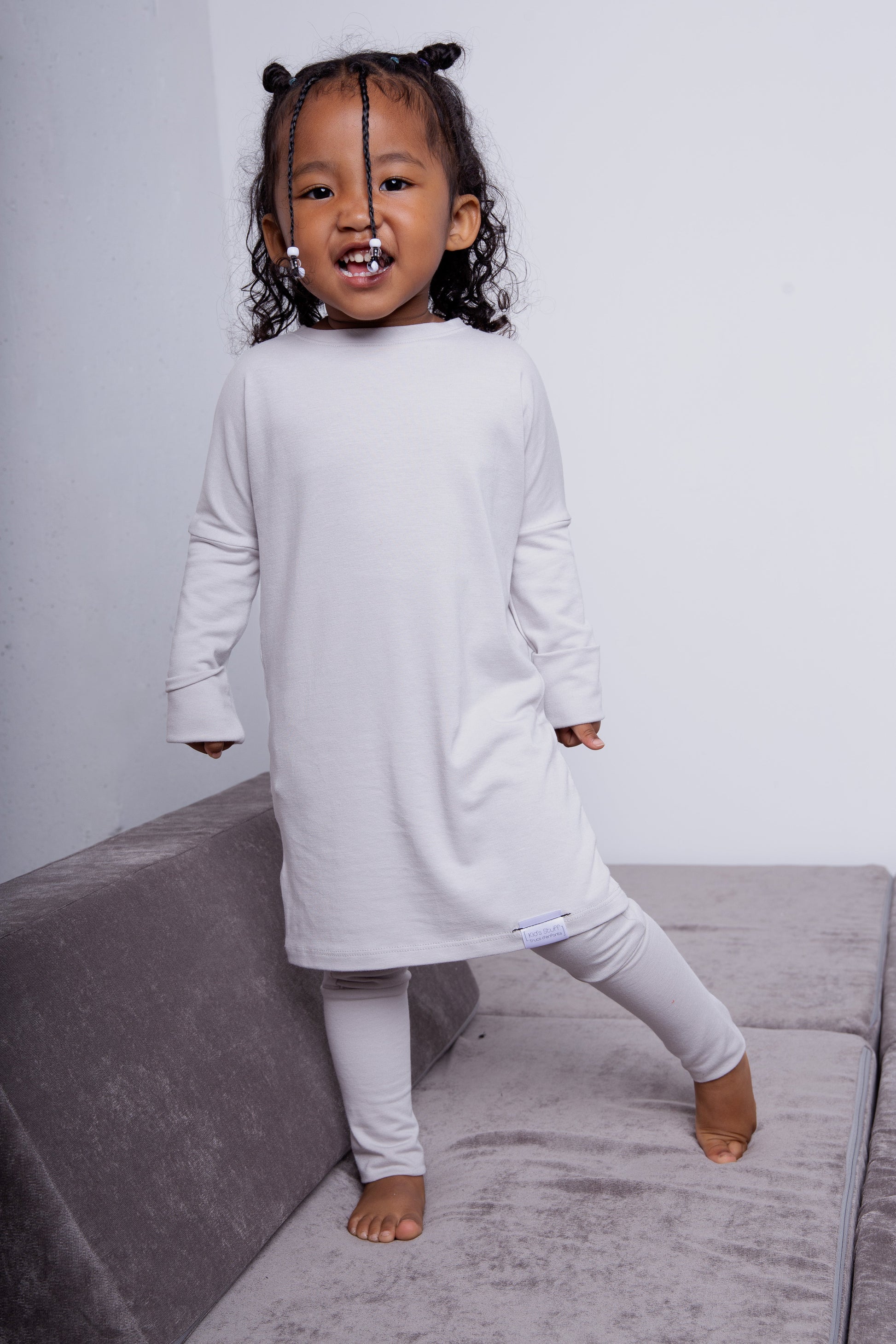 Taupe grow-with-me shirt for toddlers and kids, designed to be worn as a dress, tunic, or long shirt. Seamless shoulders and soft, eco-friendly fabric. Ethically made in Canada.