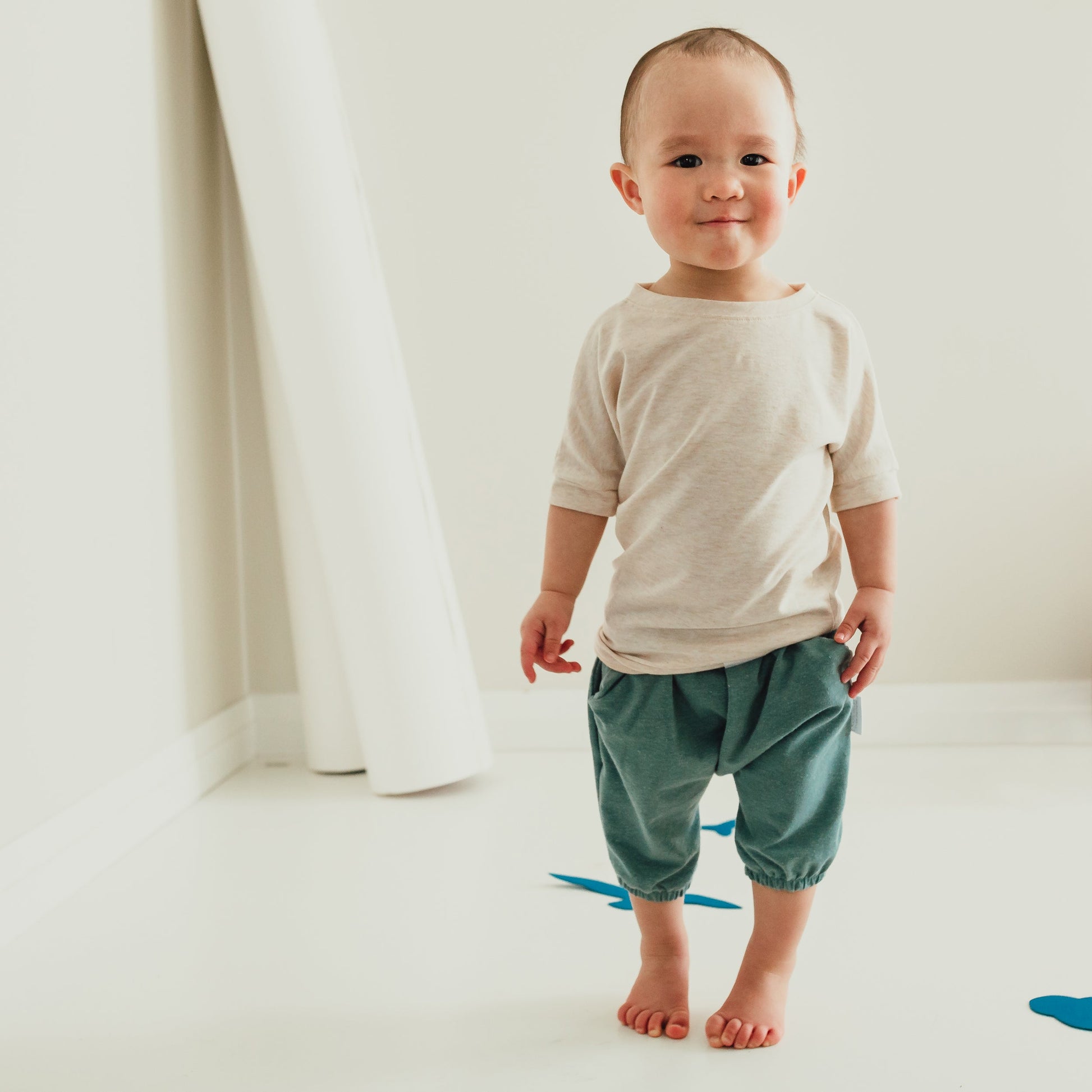 Heather Cream grow-with-me t-shirt for kids, made from soft Lyocell. Ethically made in Canada for a sustainable and comfy fit.