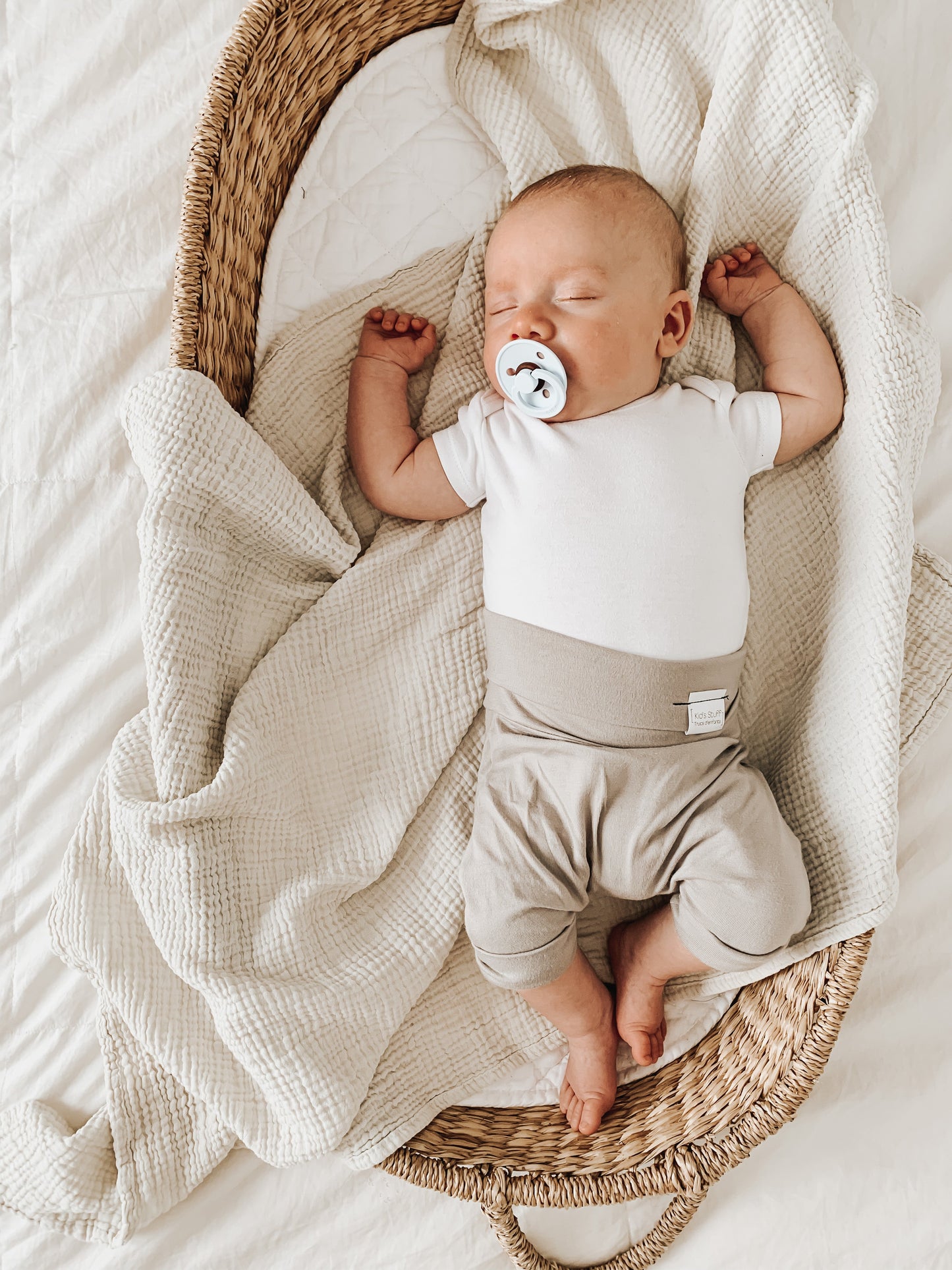 Taupe grow-with-me shorts for kids, made from soft organic cotton with a stretchy, foldable waistband. Ethically made in Canada for a sustainable and comfy fit.
