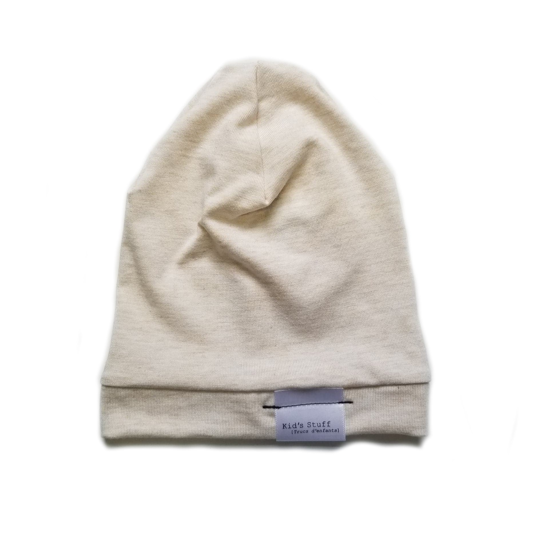 Soft and stretchy heather cream beanie for kids, made from eco-friendly fabric. Ethically crafted in Canada, featuring a fold-over brim and minimalist design