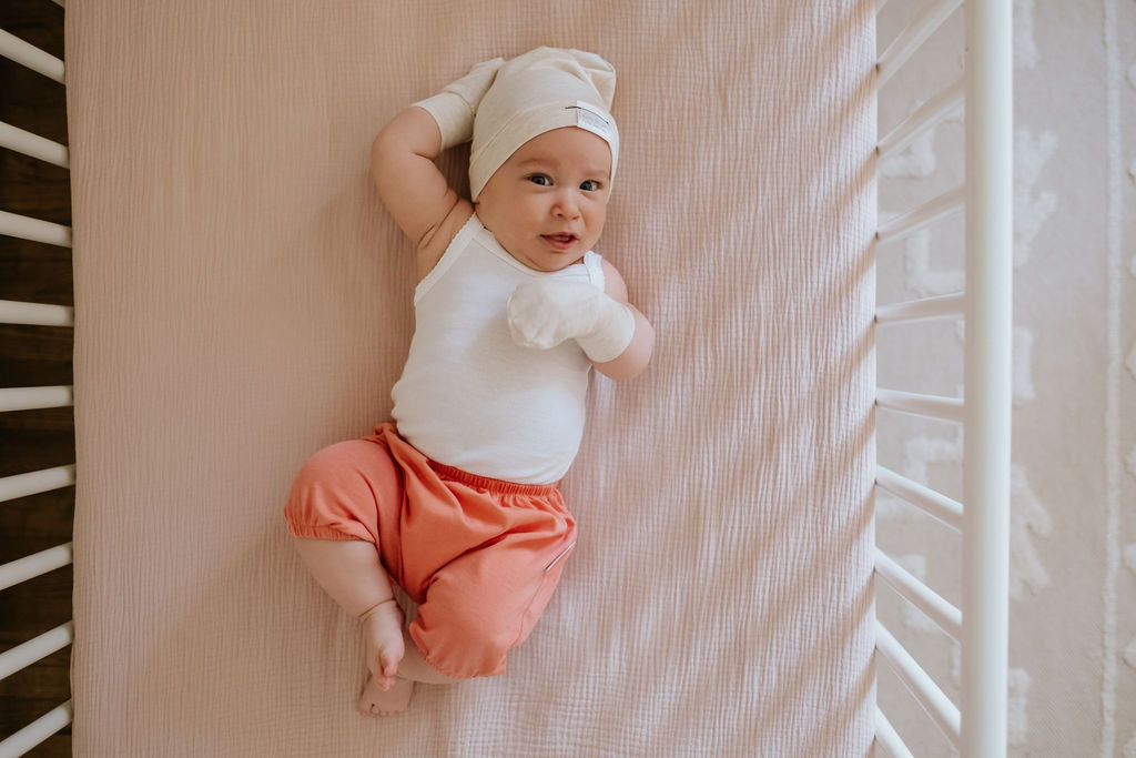 Soft and stretchy Heather cream  beanie for kids, made from eco-friendly fabric. Ethically crafted in Canada, featuring a fold-over brim and minimalist design