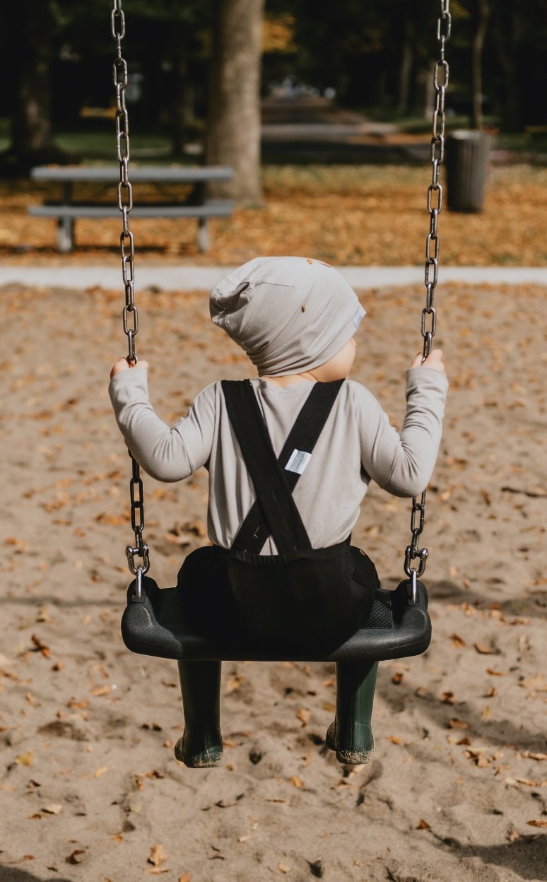 Soft and stretchy taupe beanie for kids, made from eco-friendly fabric. Ethically crafted in Canada, featuring a fold-over brim and minimalist design