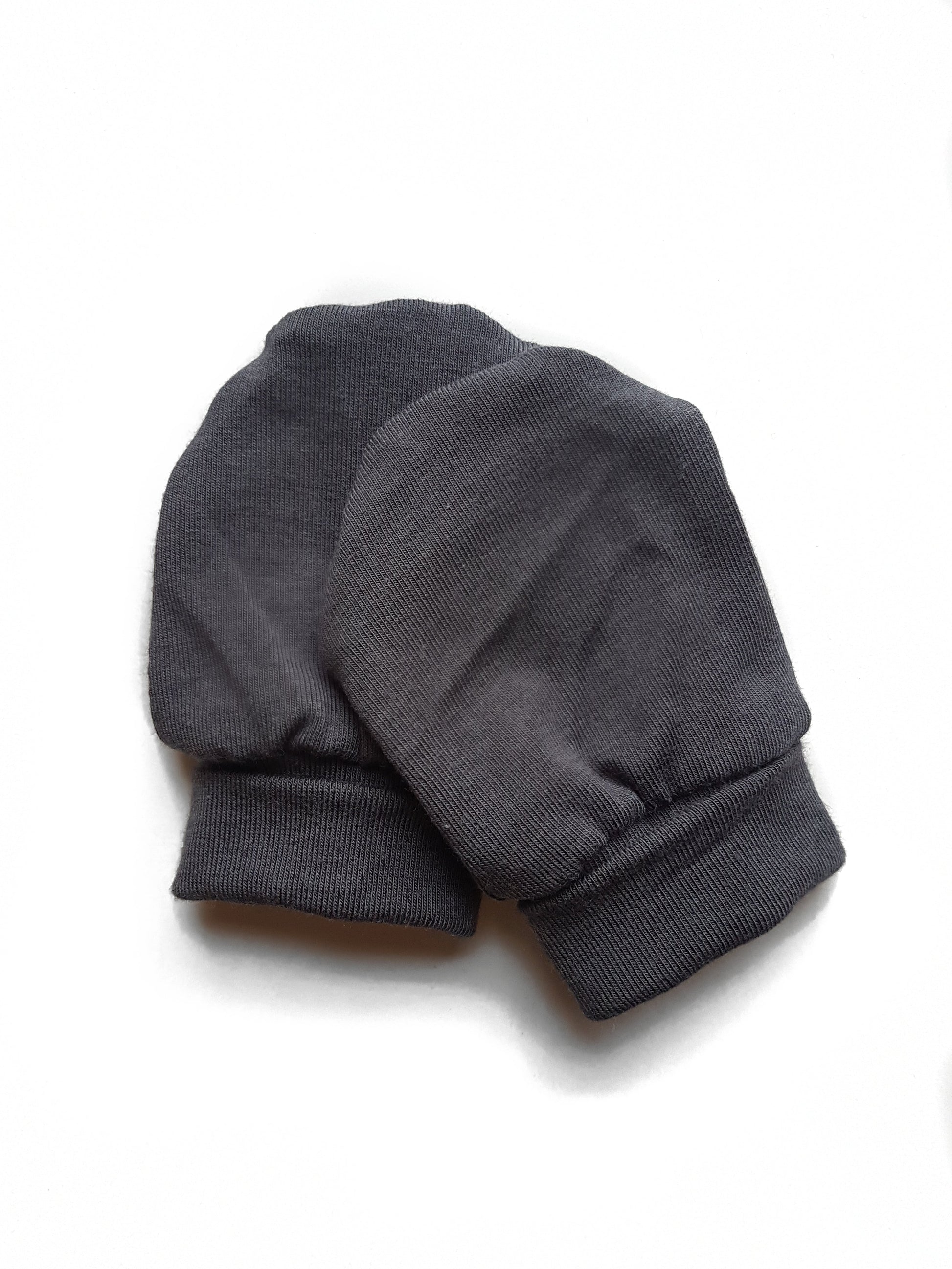 Soft and eco-friendly dark grey newborn mittens, designed to protect delicate skin and prevent scratching. Ethically made in Canada for ultimate comfort and warmth