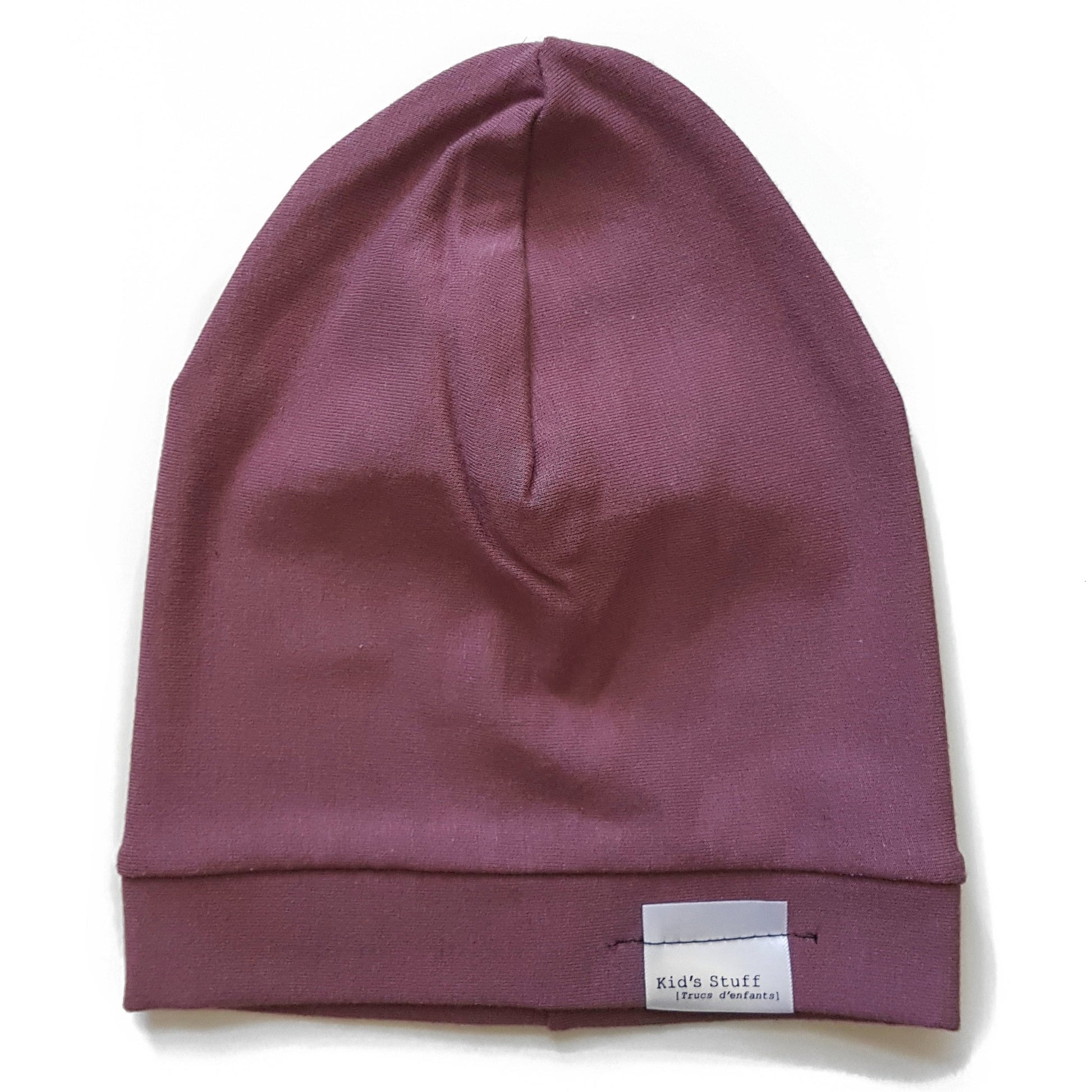 Soft and stretchy rose brown beanie for kids, made from eco-friendly fabric. Ethically crafted in Canada, featuring a fold-over brim and minimalist design
