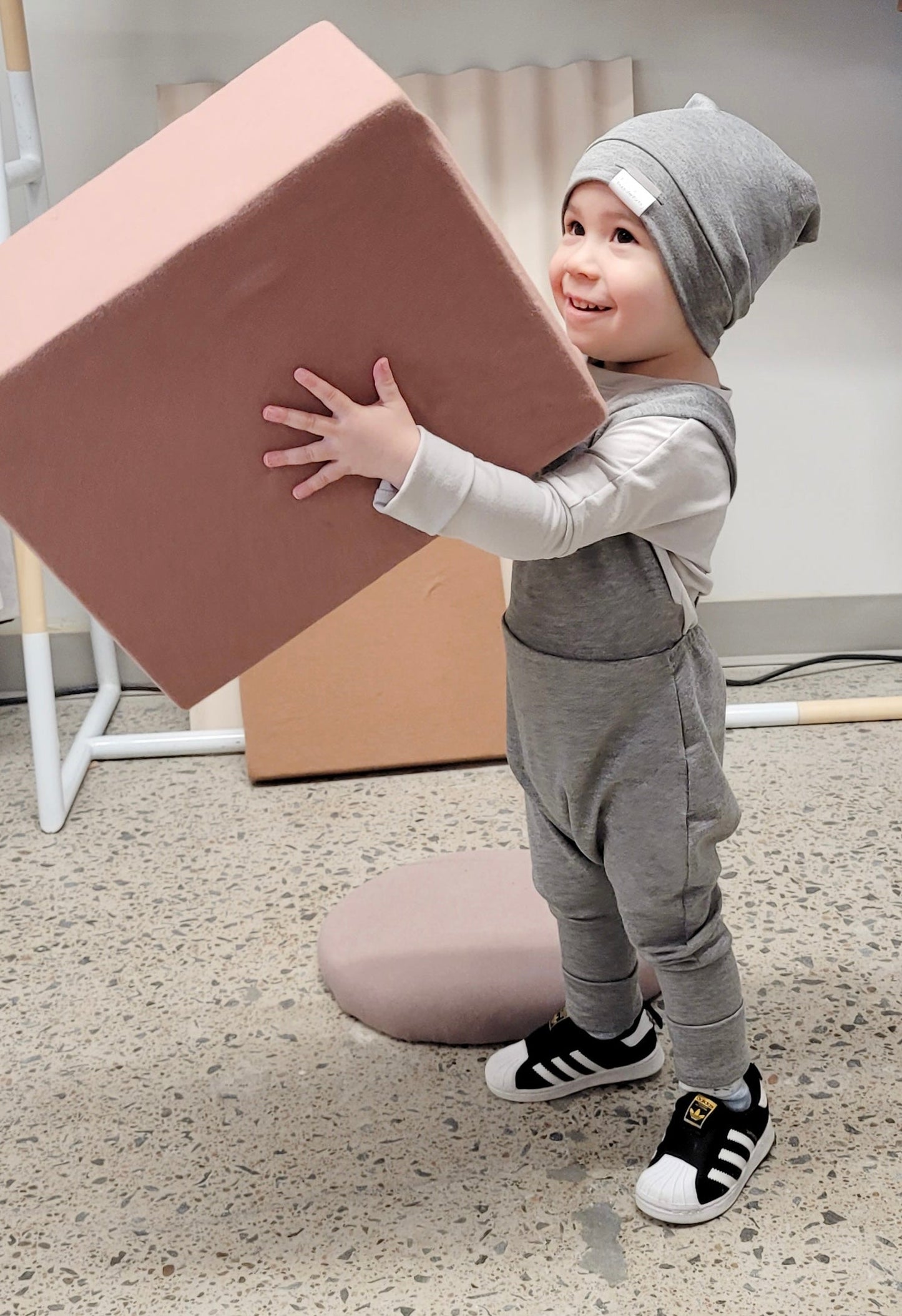 Soft and stretchy grey cloud beanie for kids, made from eco-friendly fabric. Ethically crafted in Canada, featuring a fold-over brim and minimalist design