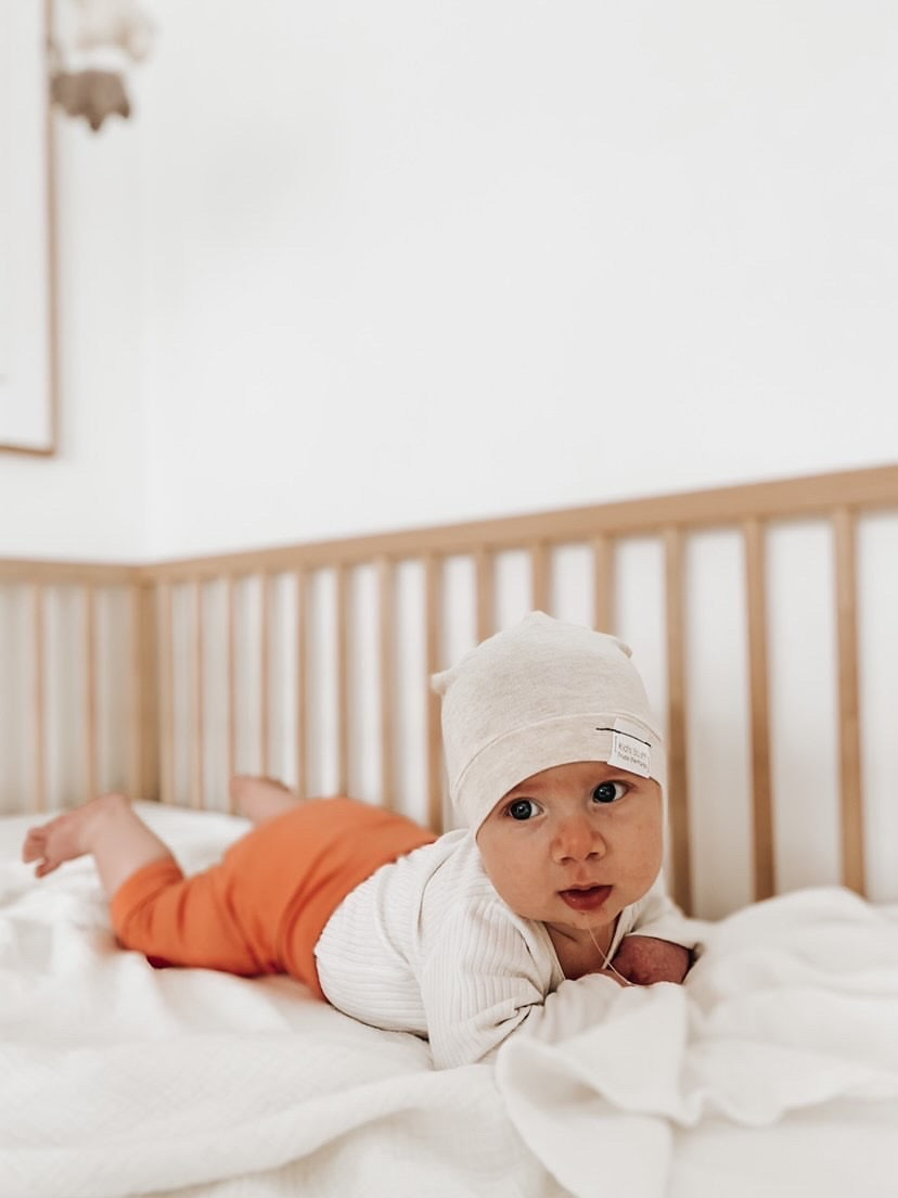 Soft and stretchy Heather cream  beanie for kids, made from eco-friendly fabric. Ethically crafted in Canada, featuring a fold-over brim and minimalist design