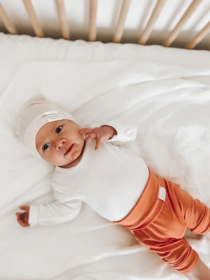 Soft and stretchy Heather cream  beanie for kids, made from eco-friendly fabric. Ethically crafted in Canada, featuring a fold-over brim and minimalist design