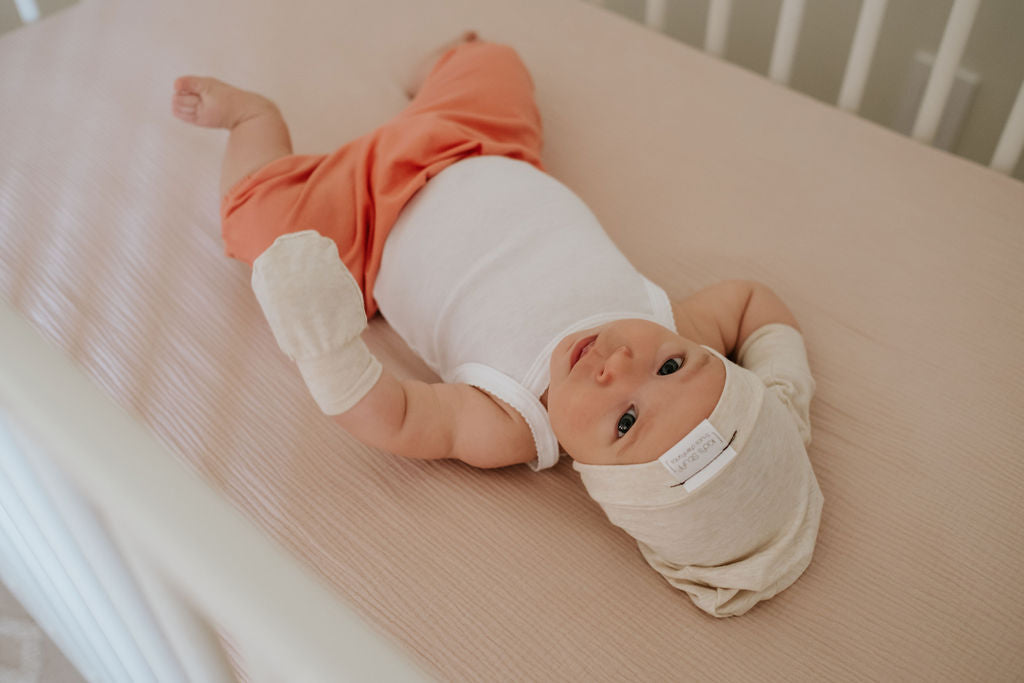 Soft and stretchy Heather cream  beanie for kids, made from eco-friendly fabric. Ethically crafted in Canada, featuring a fold-over brim and minimalist design