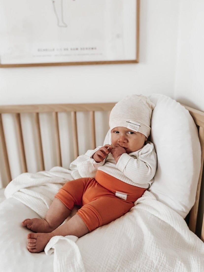 Soft and stretchy Heather cream  beanie for kids, made from eco-friendly fabric. Ethically crafted in Canada, featuring a fold-over brim and minimalist design