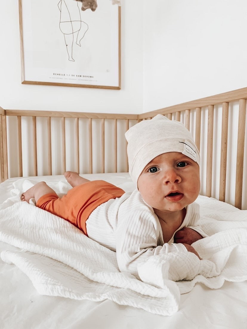 Soft and stretchy Heather cream  beanie for kids, made from eco-friendly fabric. Ethically crafted in Canada, featuring a fold-over brim and minimalist design