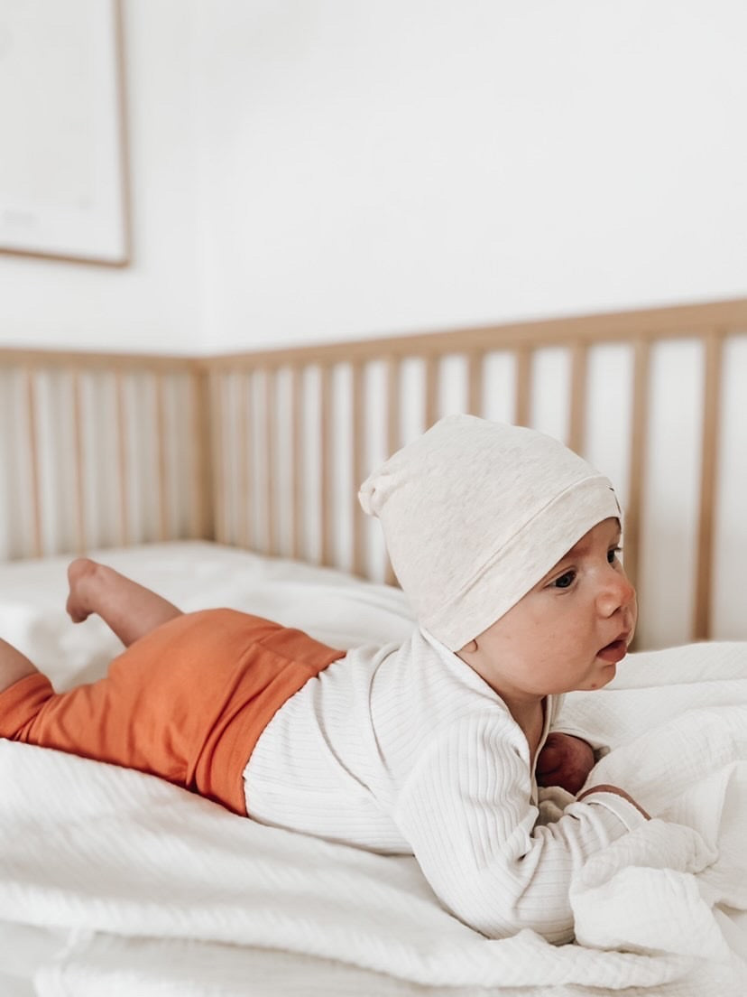 Soft and stretchy Heather cream  beanie for kids, made from eco-friendly fabric. Ethically crafted in Canada, featuring a fold-over brim and minimalist design