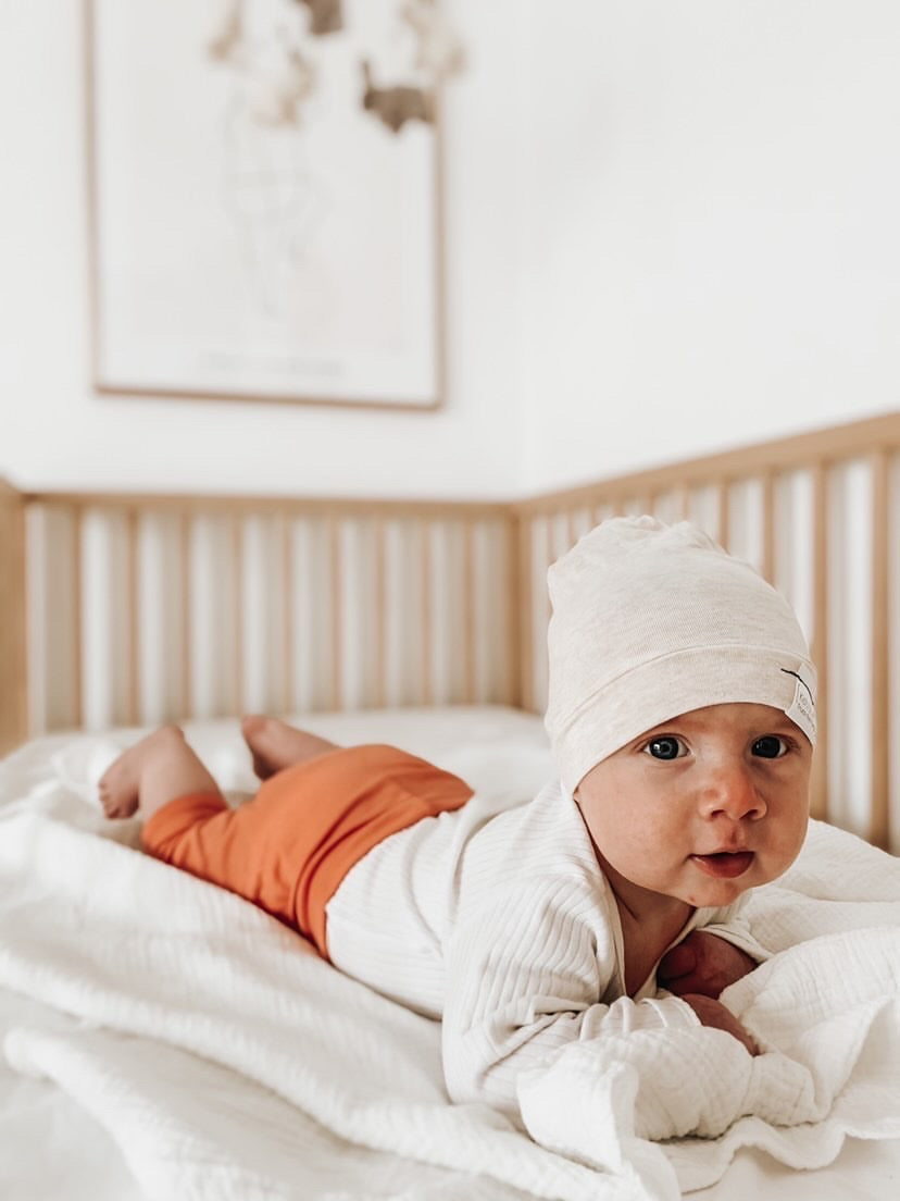 Soft and stretchy Heather cream  beanie for kids, made from eco-friendly fabric. Ethically crafted in Canada, featuring a fold-over brim and minimalist design