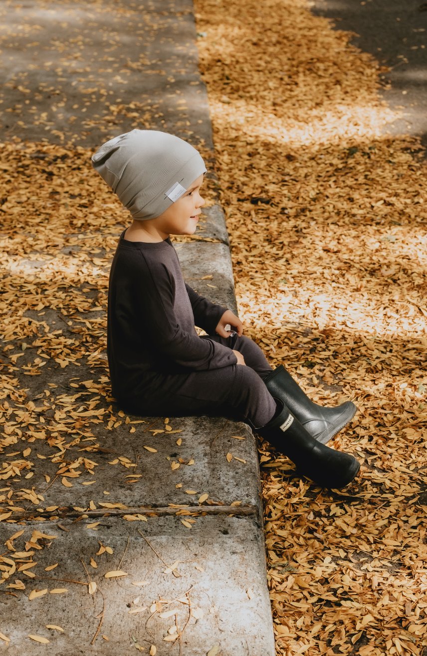 Soft and stretchy taupe beanie for kids, made from eco-friendly fabric. Ethically crafted in Canada, featuring a fold-over brim and minimalist design