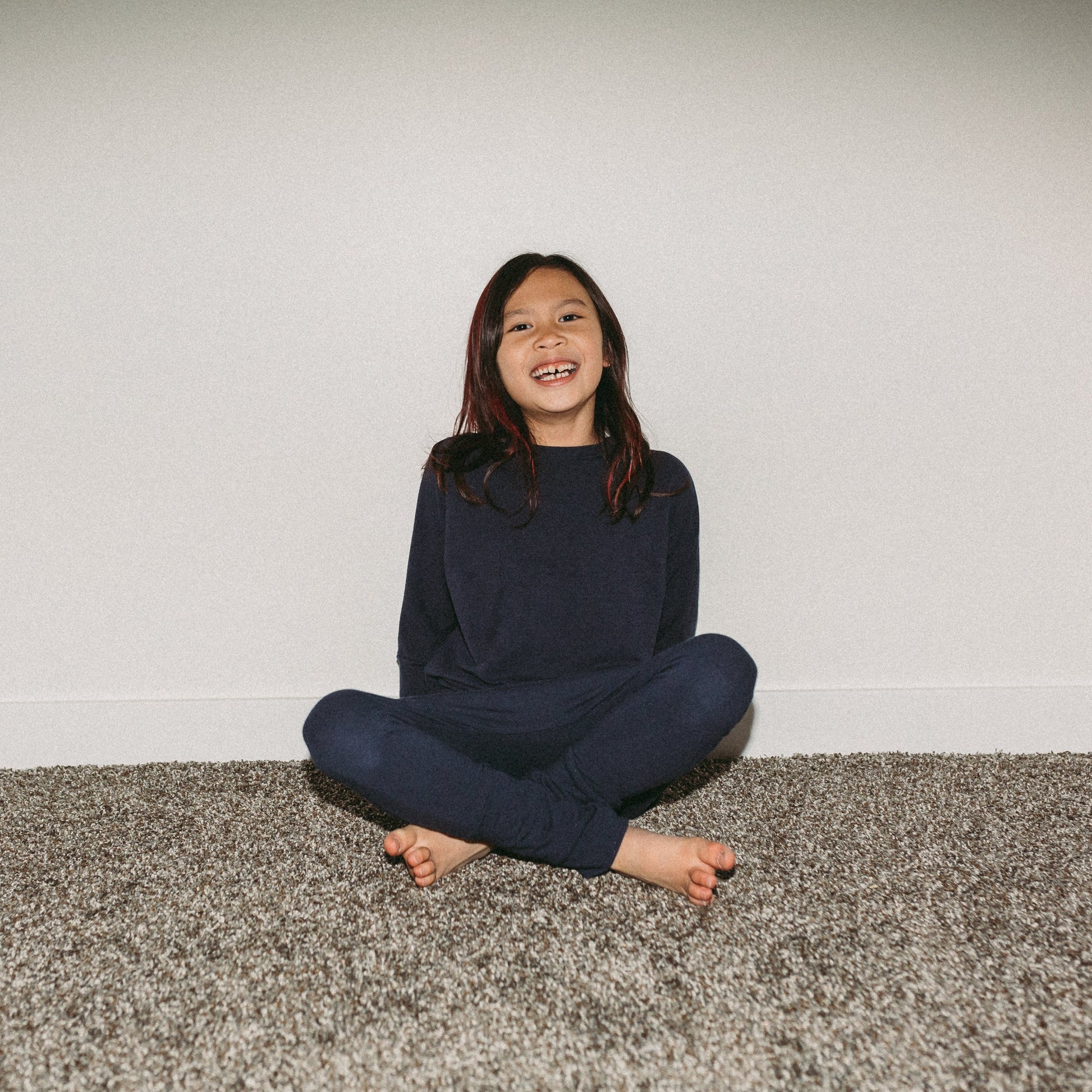 Navy grow-with-me pants for toddlers and kids, made from soft, eco-friendly fabric. Adjustable waistband and cuffs for extended wear. Ethically made in Canada.