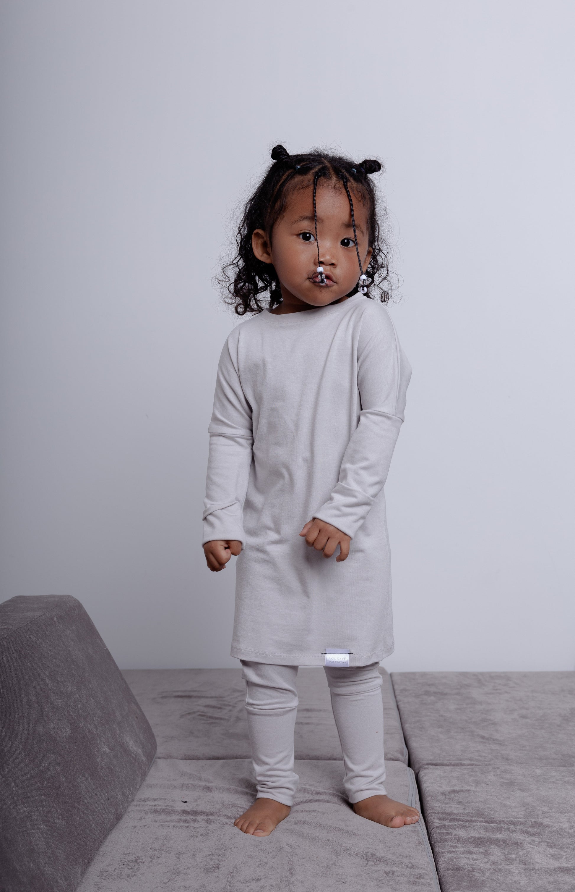 Taupe grow-with-me pants for toddlers and kids, made from soft, eco-friendly fabric. Adjustable waistband and cuffs for extended wear. Ethically made in Canada.