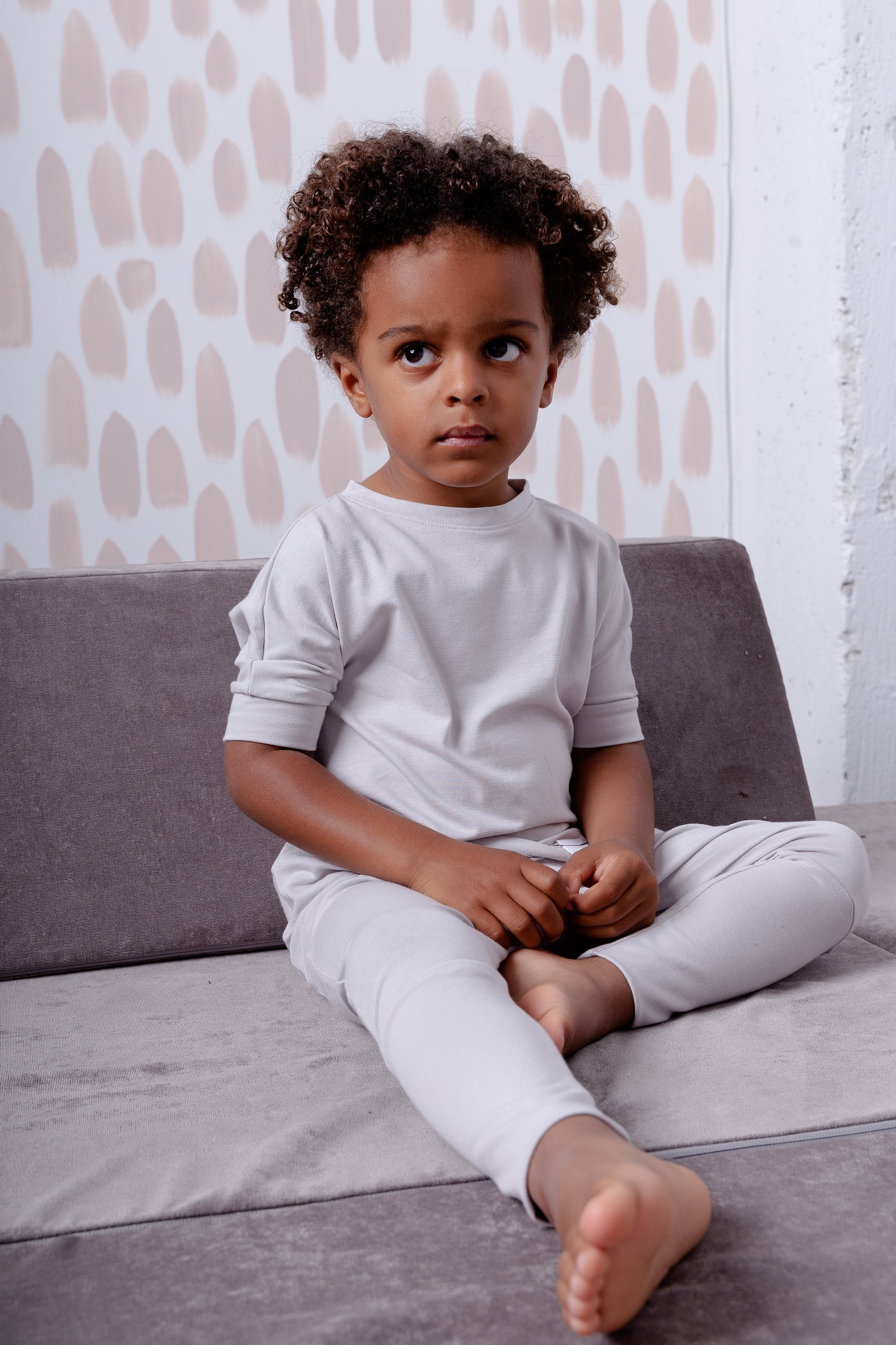Taupe grow-with-me pants for toddlers and kids, made from soft, eco-friendly fabric. Adjustable waistband and cuffs for extended wear. Ethically made in Canada.