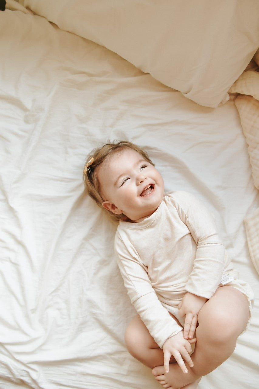 Heather Cream grow-with-me shirt for toddlers and kids, designed to be worn as a dress, tunic, or long shirt. Seamless shoulders and soft, eco-friendly fabric. Ethically made in Canada.