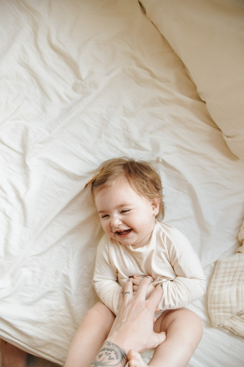 Heather Cream grow-with-me shirt for toddlers and kids, designed to be worn as a dress, tunic, or long shirt. Seamless shoulders and soft, eco-friendly fabric. Ethically made in Canada.