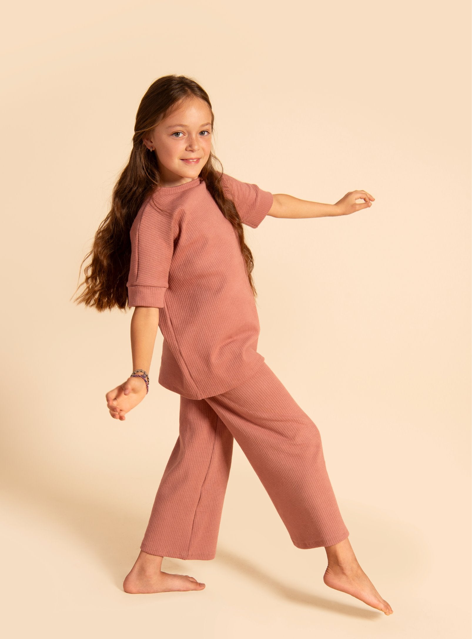 Dark Rose grow-with-me t-shirt for kids, made from soft organic cotton with a stretchy, foldable waistband. Ethically made in Canada for a sustainable and comfy fit.