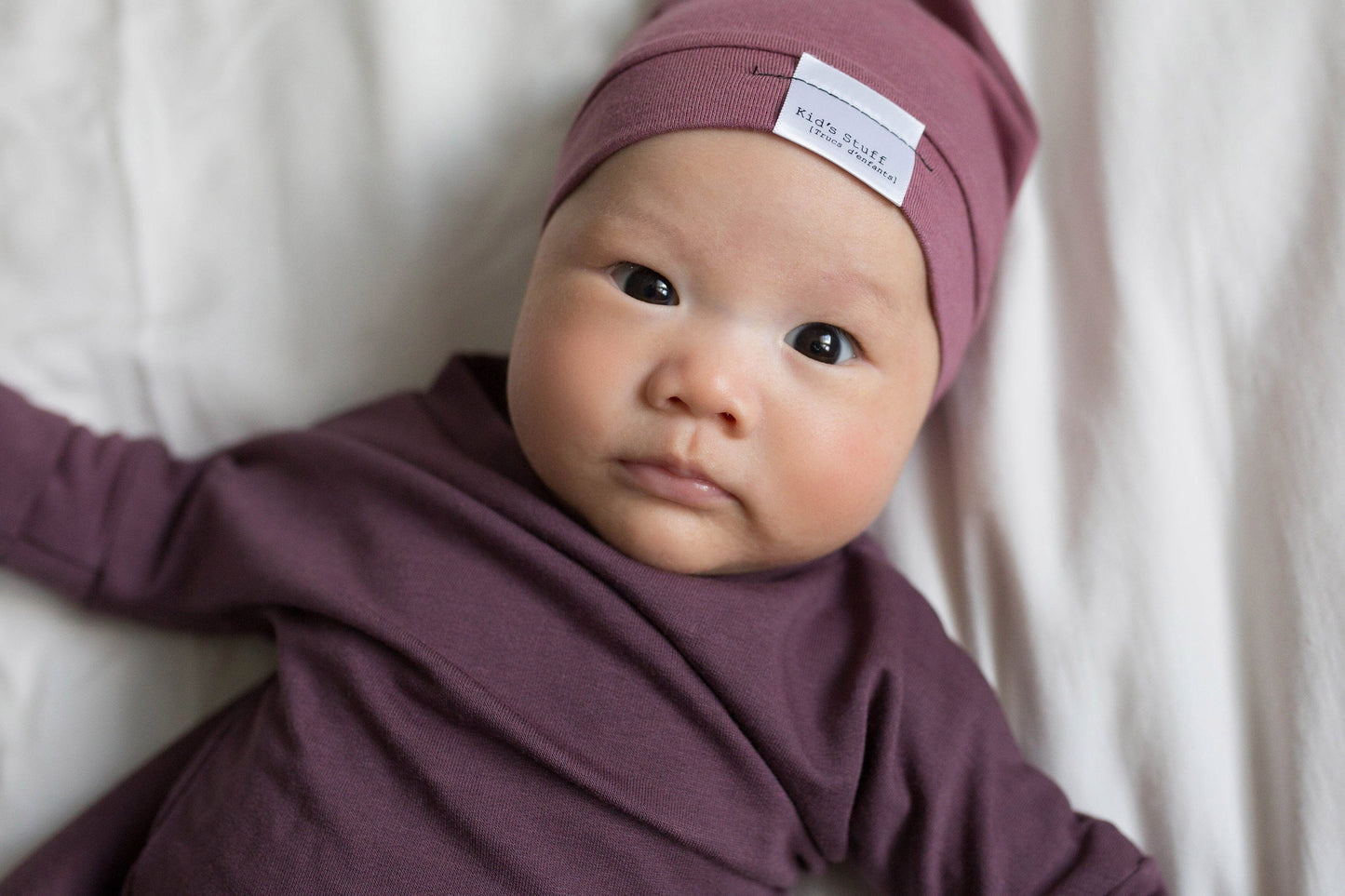 Soft and stretchy rose brown beanie for kids, made from eco-friendly fabric. Ethically crafted in Canada, featuring a fold-over brim and minimalist design