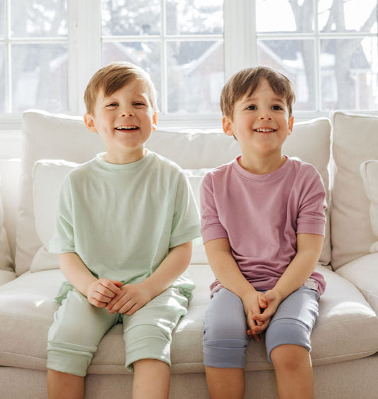 Lime grow-with-me shorts for kids, made from soft organic cotton with a stretchy, foldable waistband. Ethically made in Canada for a sustainable and comfy fit.