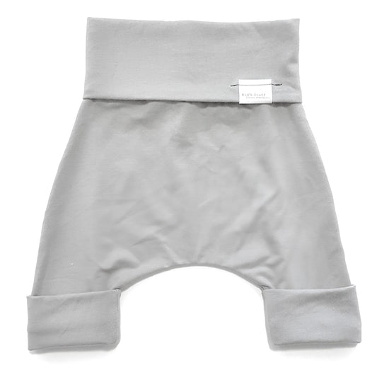 Taupe grow-with-me shorts for kids, made from soft organic cotton with a stretchy, foldable waistband. Ethically made in Canada for a sustainable and comfy fit.