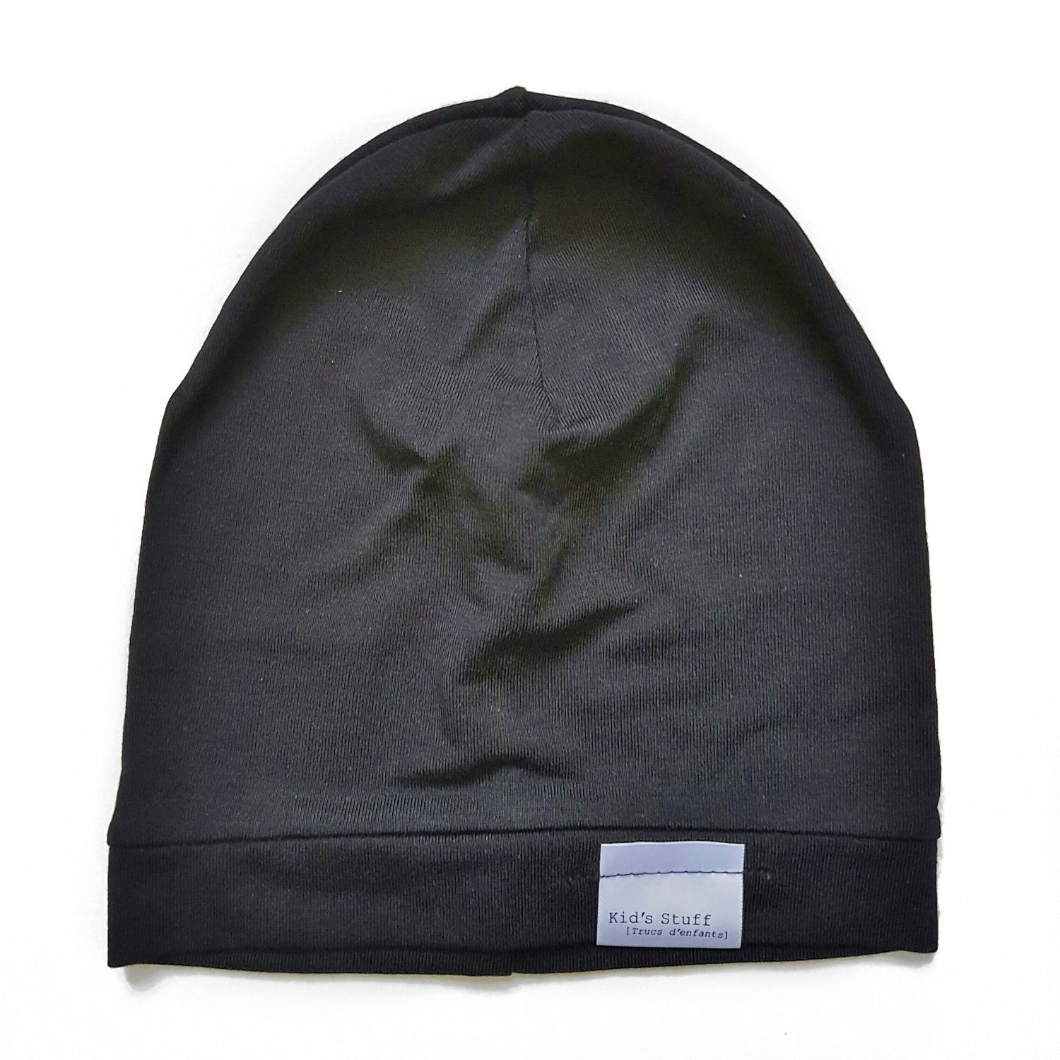 Soft and stretchy black beanie for kids, made from eco-friendly fabric. Ethically crafted in Canada, featuring a fold-over brim and minimalist design