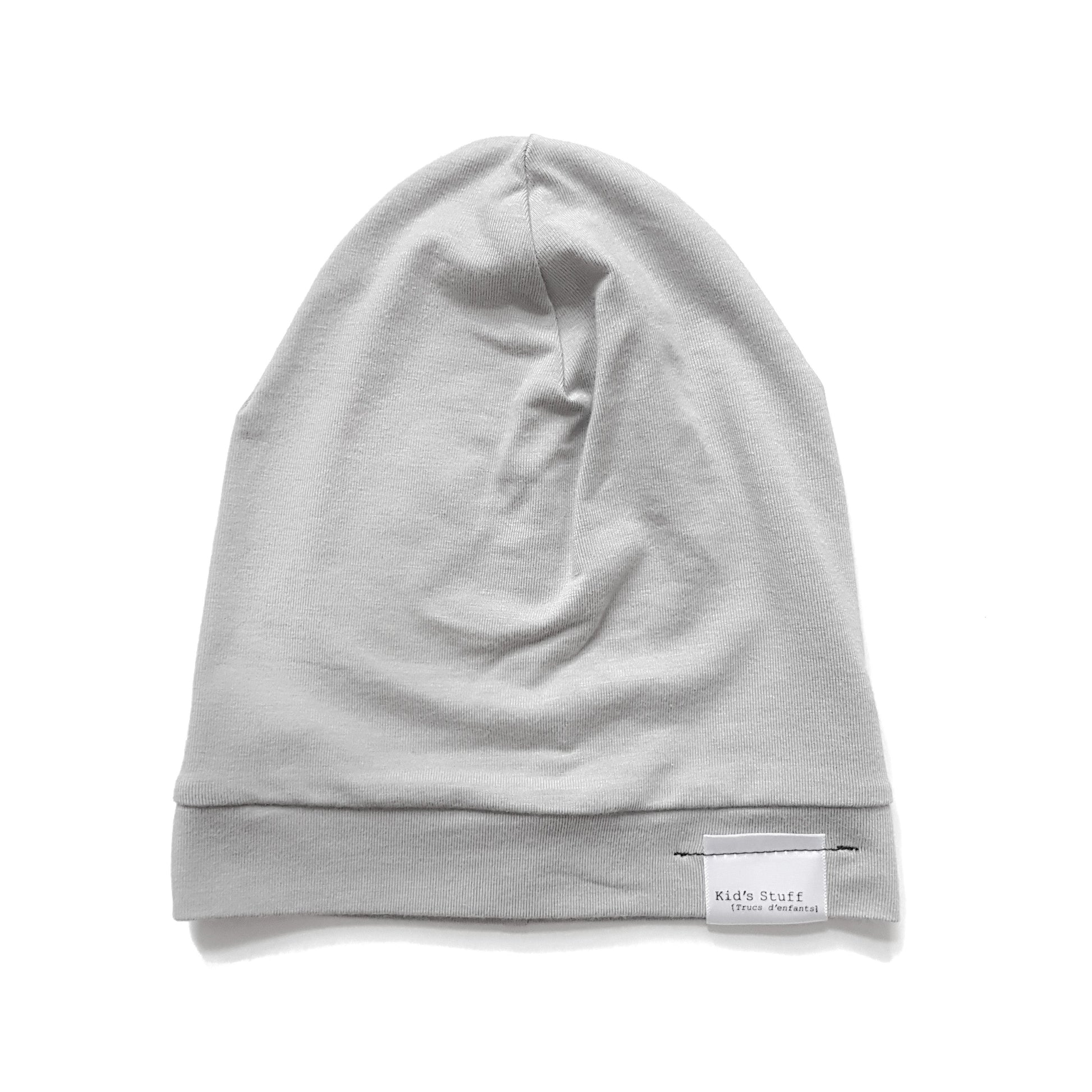 Soft and stretchy taupe beanie for kids, made from eco-friendly fabric. Ethically crafted in Canada, featuring a fold-over brim and minimalist design
