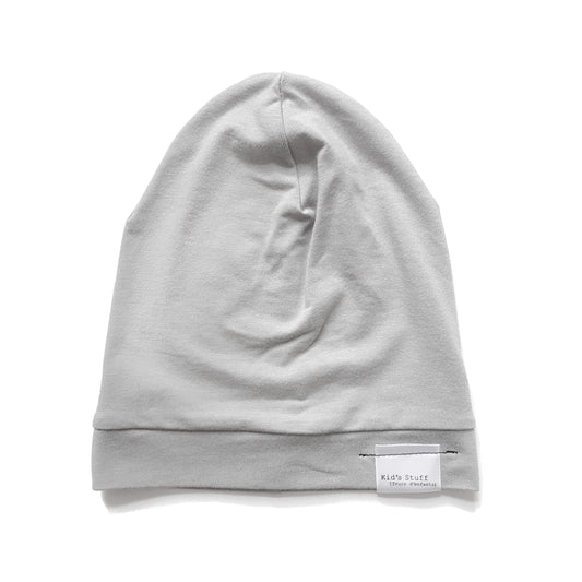 Soft and stretchy taupe beanie for kids, made from eco-friendly fabric. Ethically crafted in Canada, featuring a fold-over brim and minimalist design